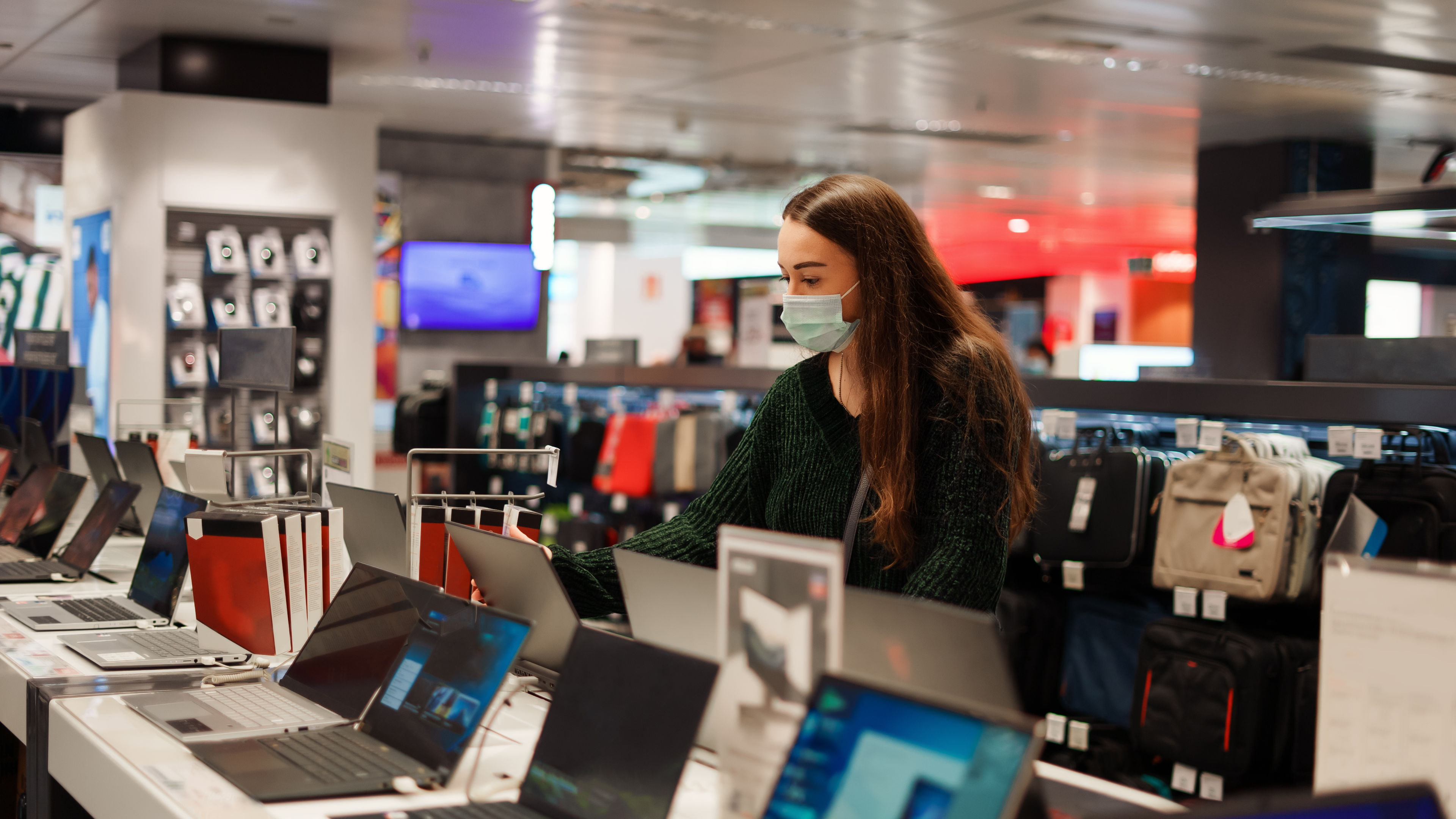 Young women selecting laptop