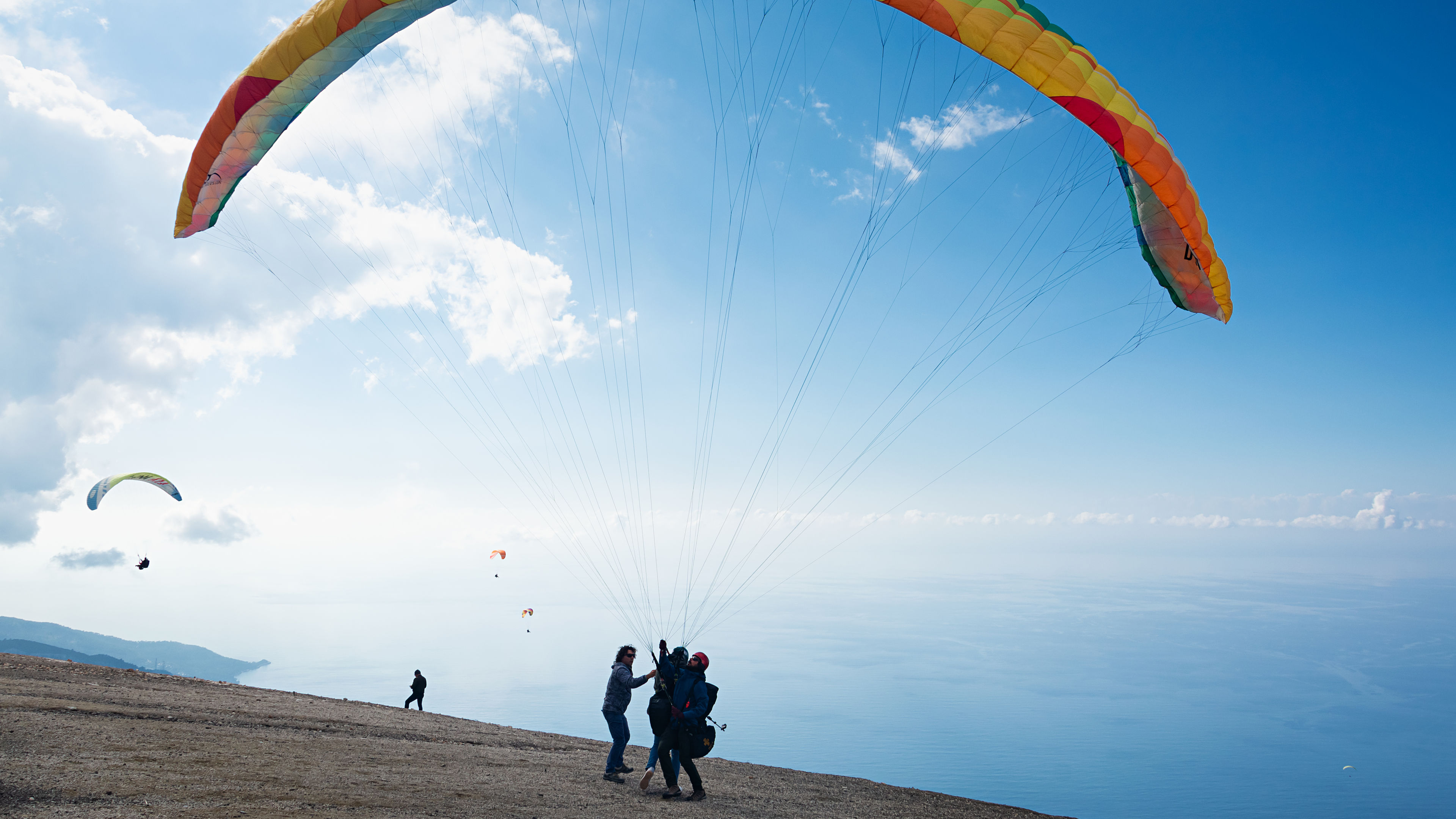 A group of people prepares for paragliding