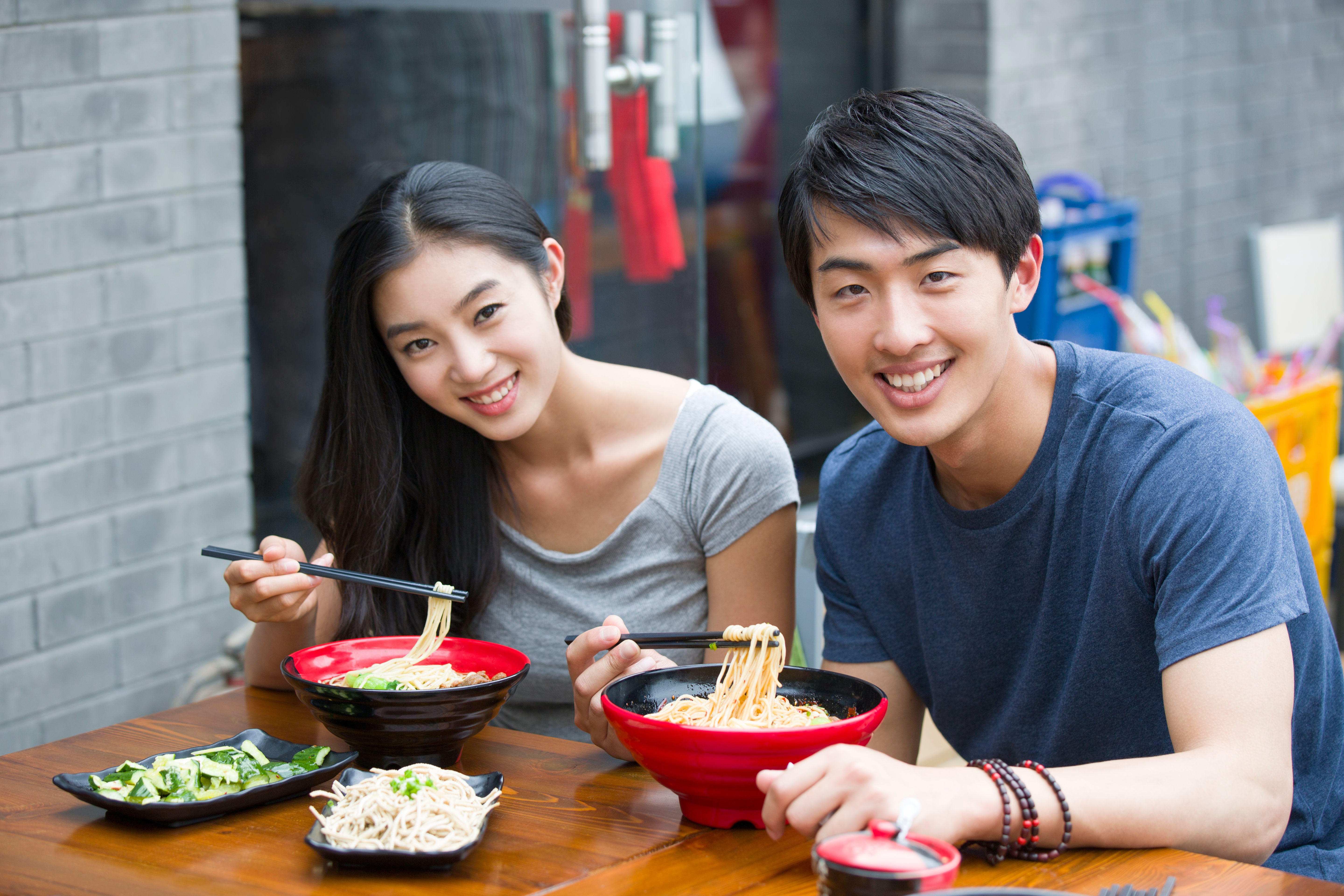 A happy young couple is having lunch together 