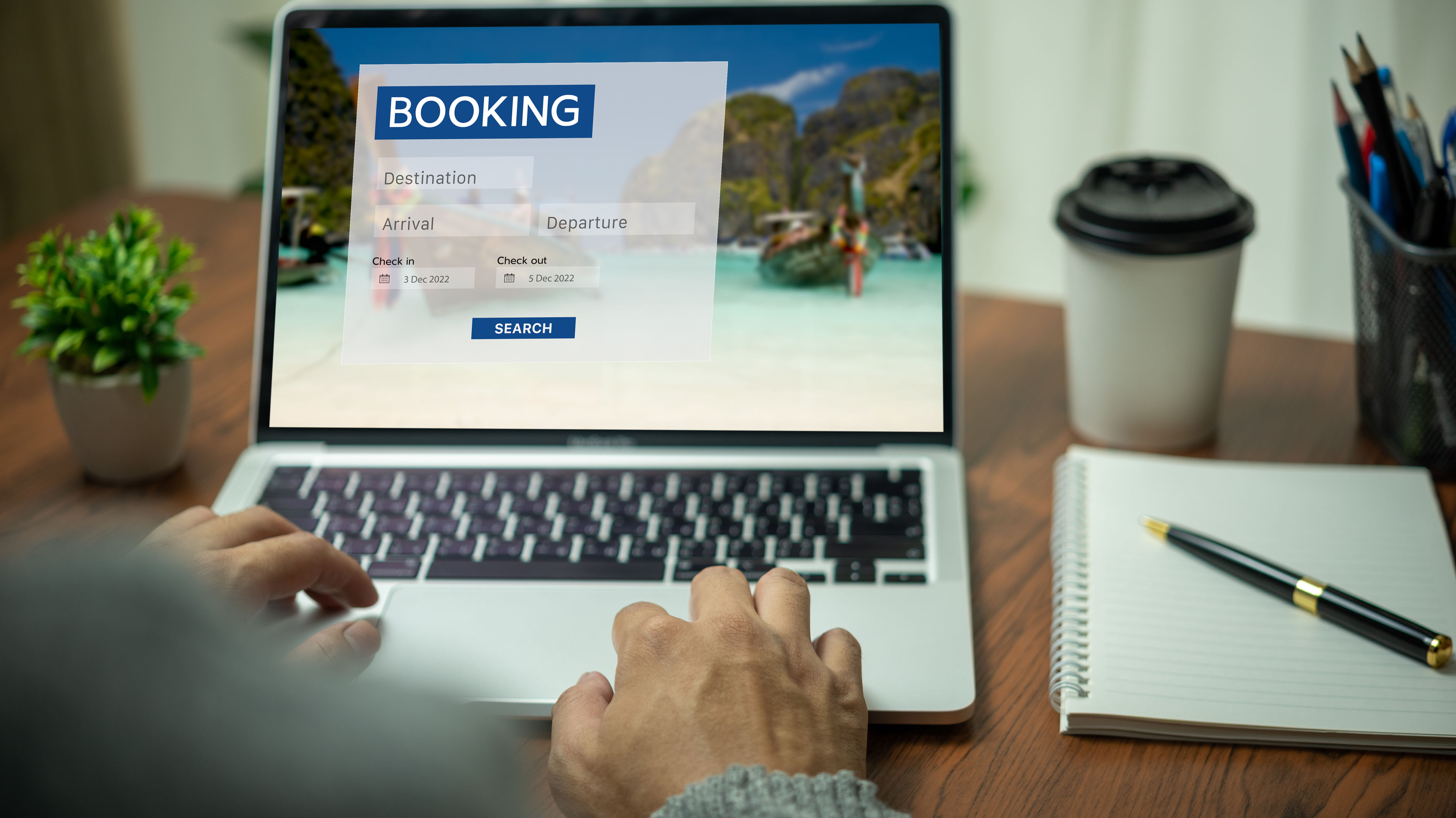 A person is browsing an online booking platform on a laptop 