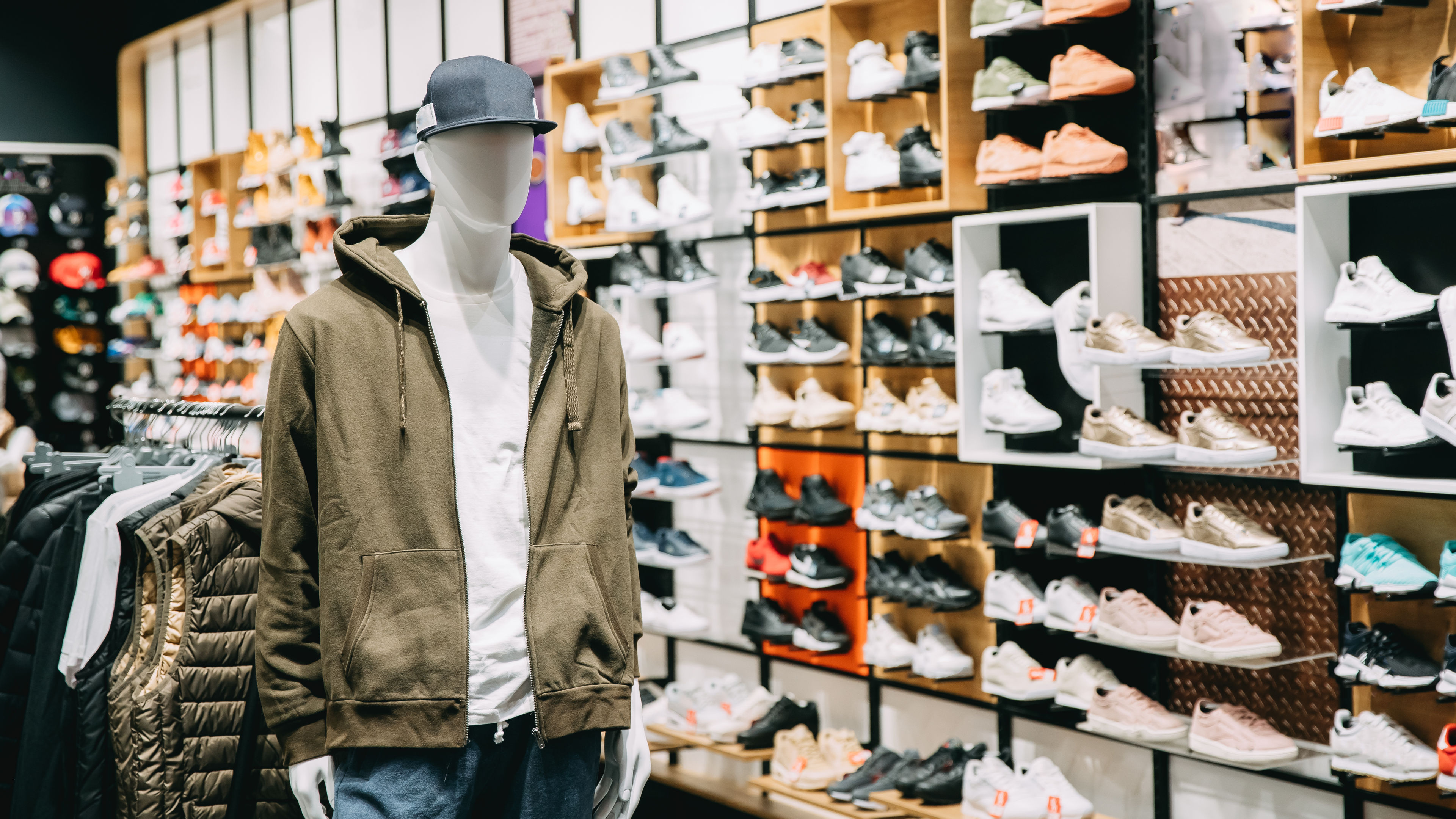 A sneaker shop displays a wide variety of sneakers. 
