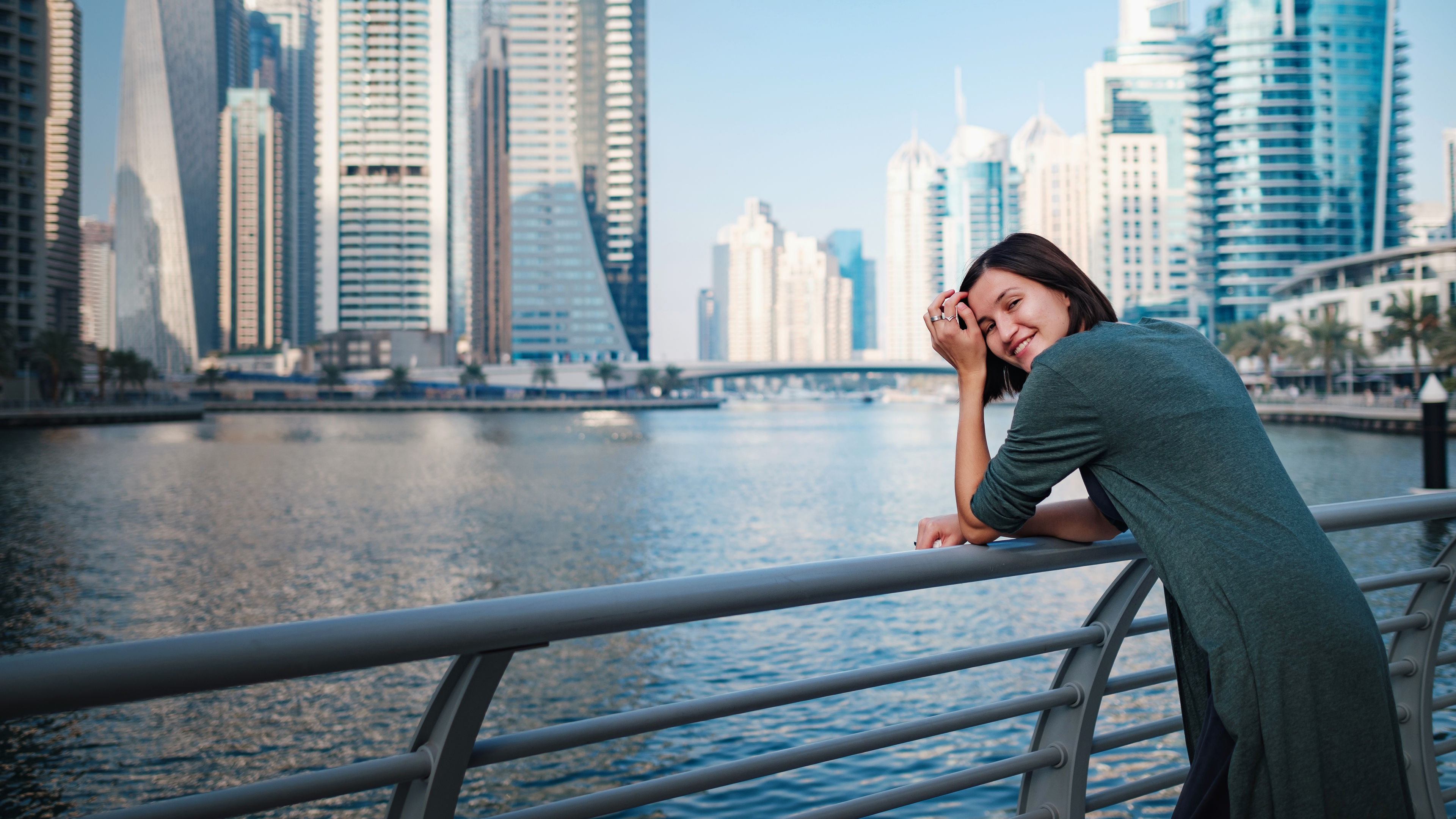 A smiling woman standing in Dubai City