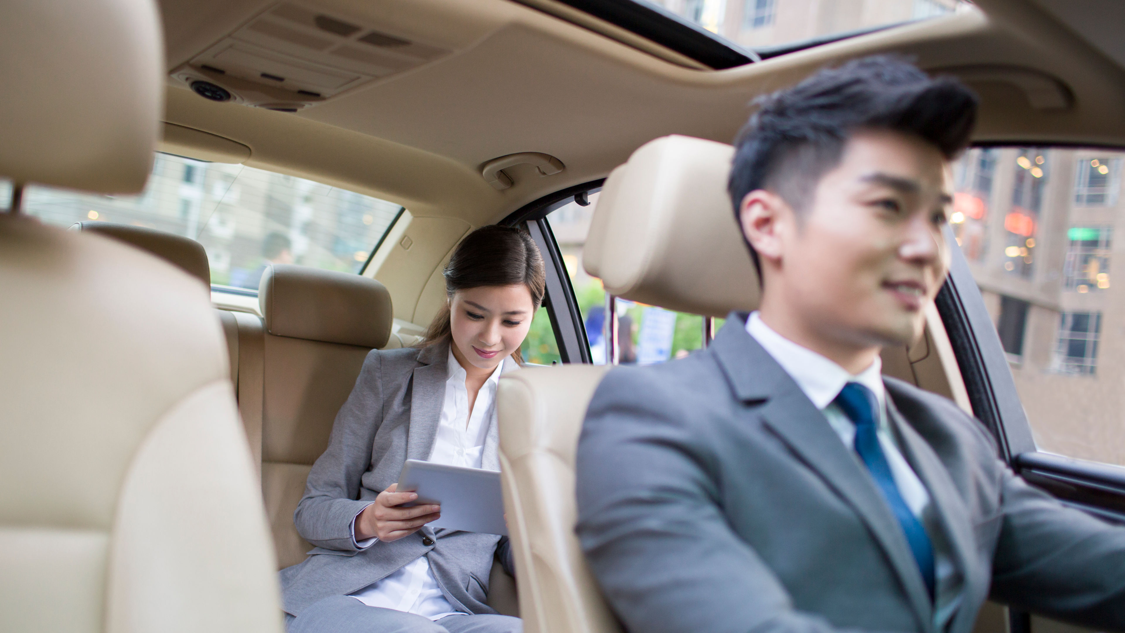 A woman in a car with a driver