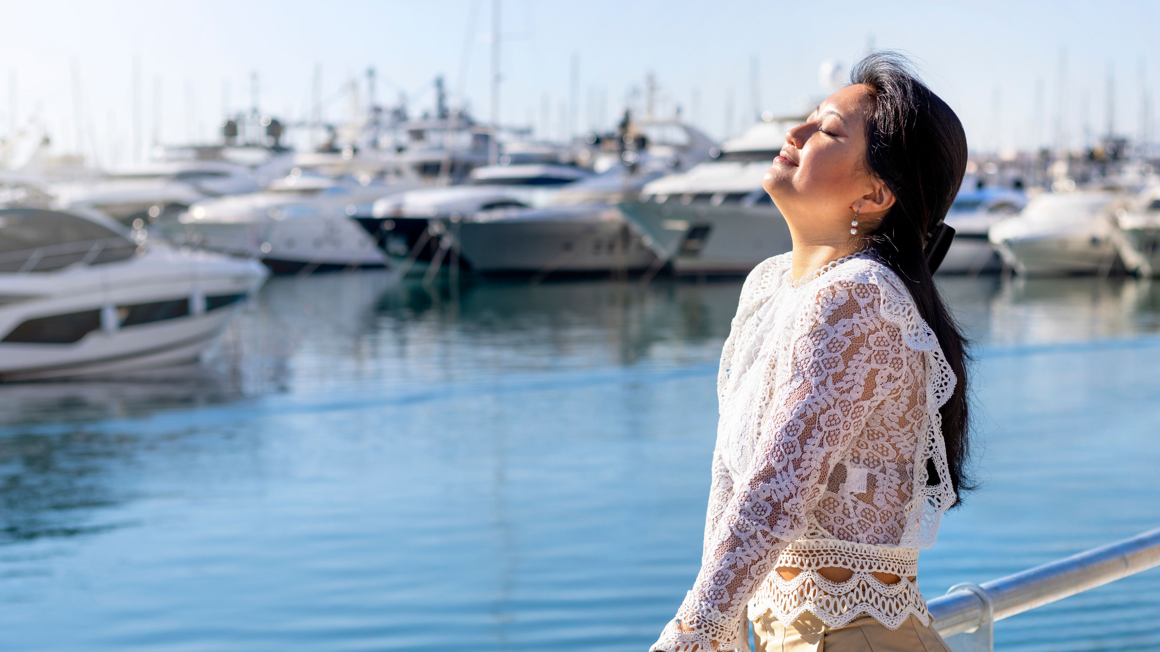 Relaxed woman breathing fresh air outdoors at seaport 