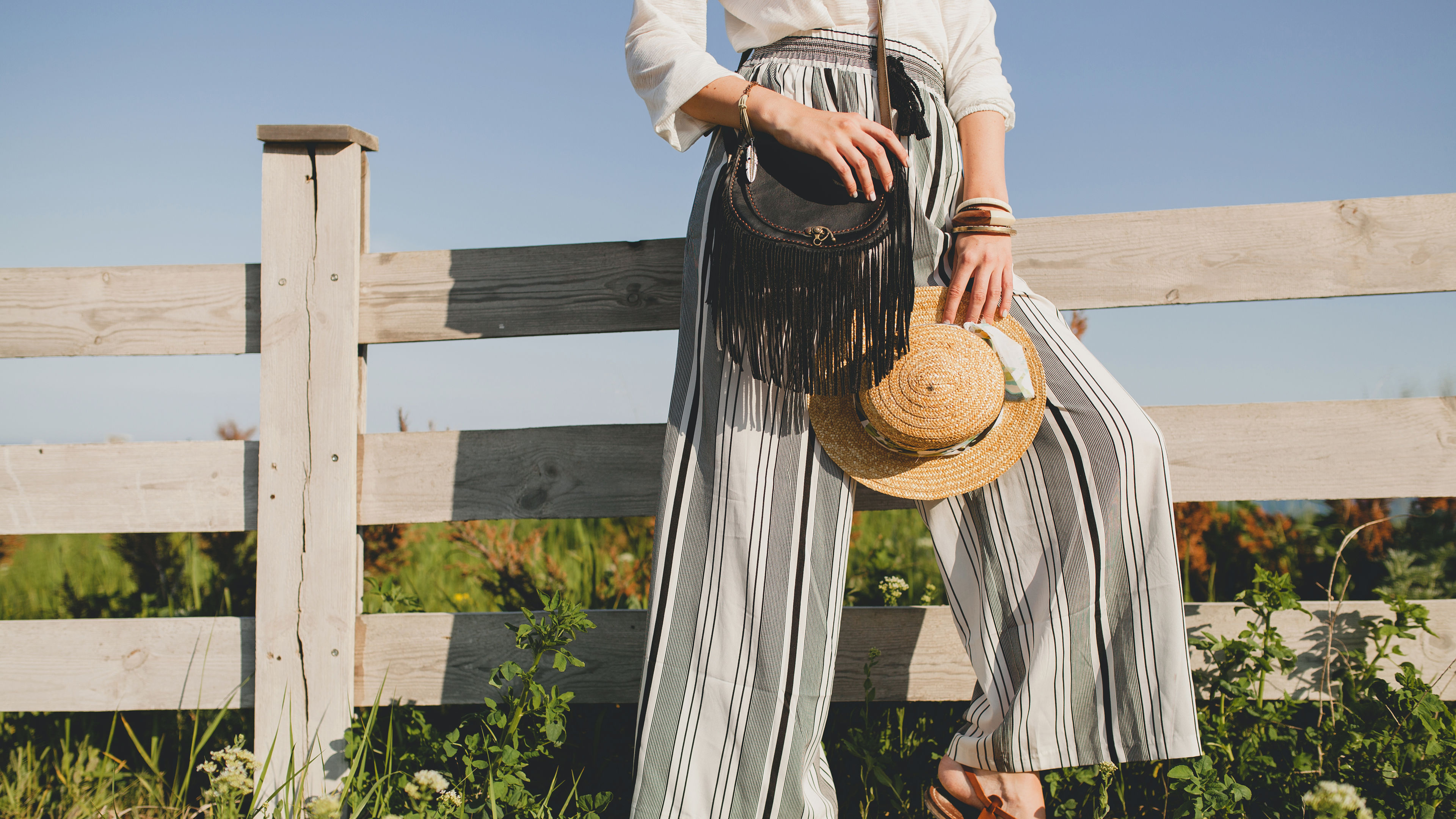 A woman in striped wide-leg pants