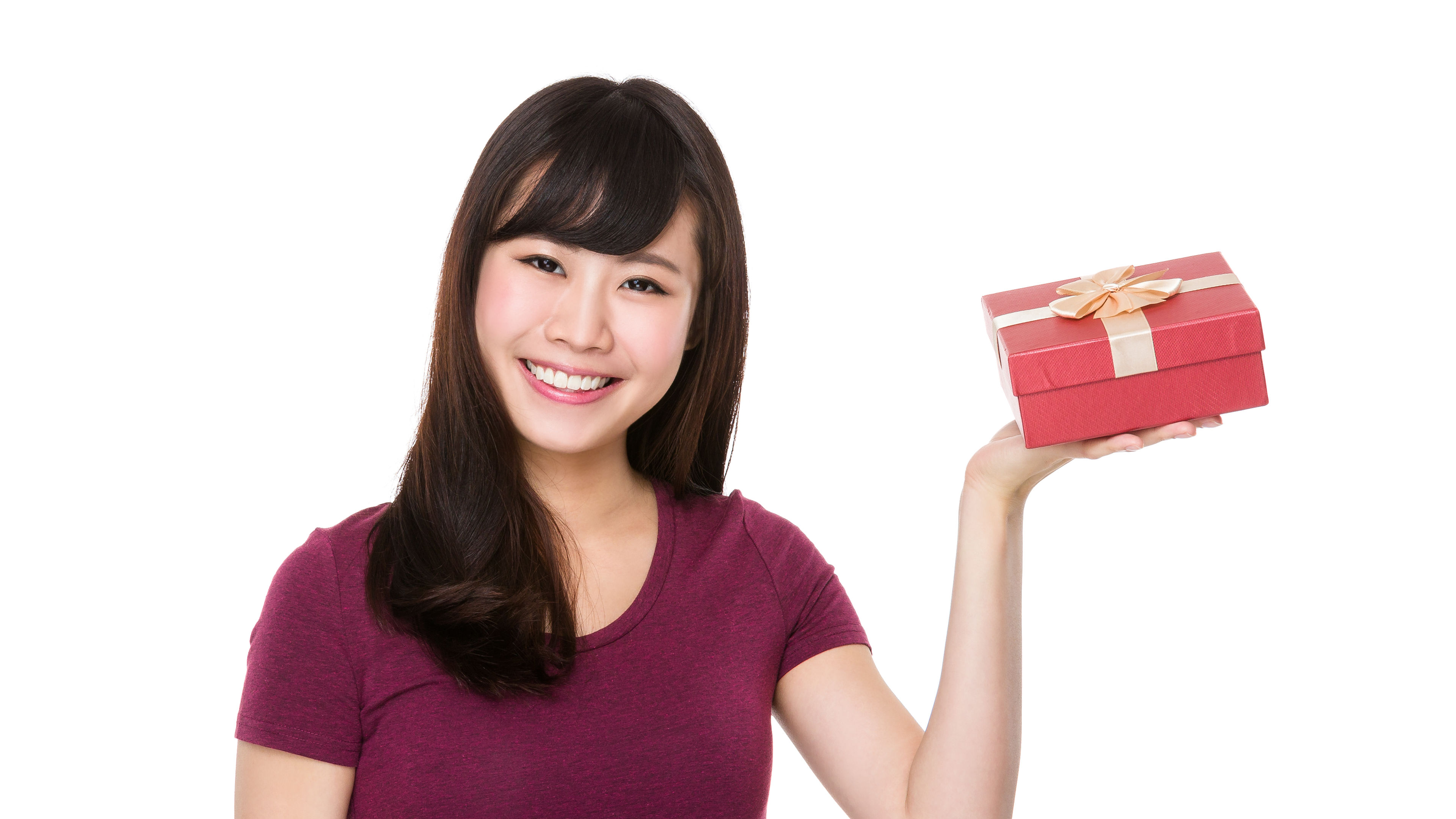A woman smiling with a gift