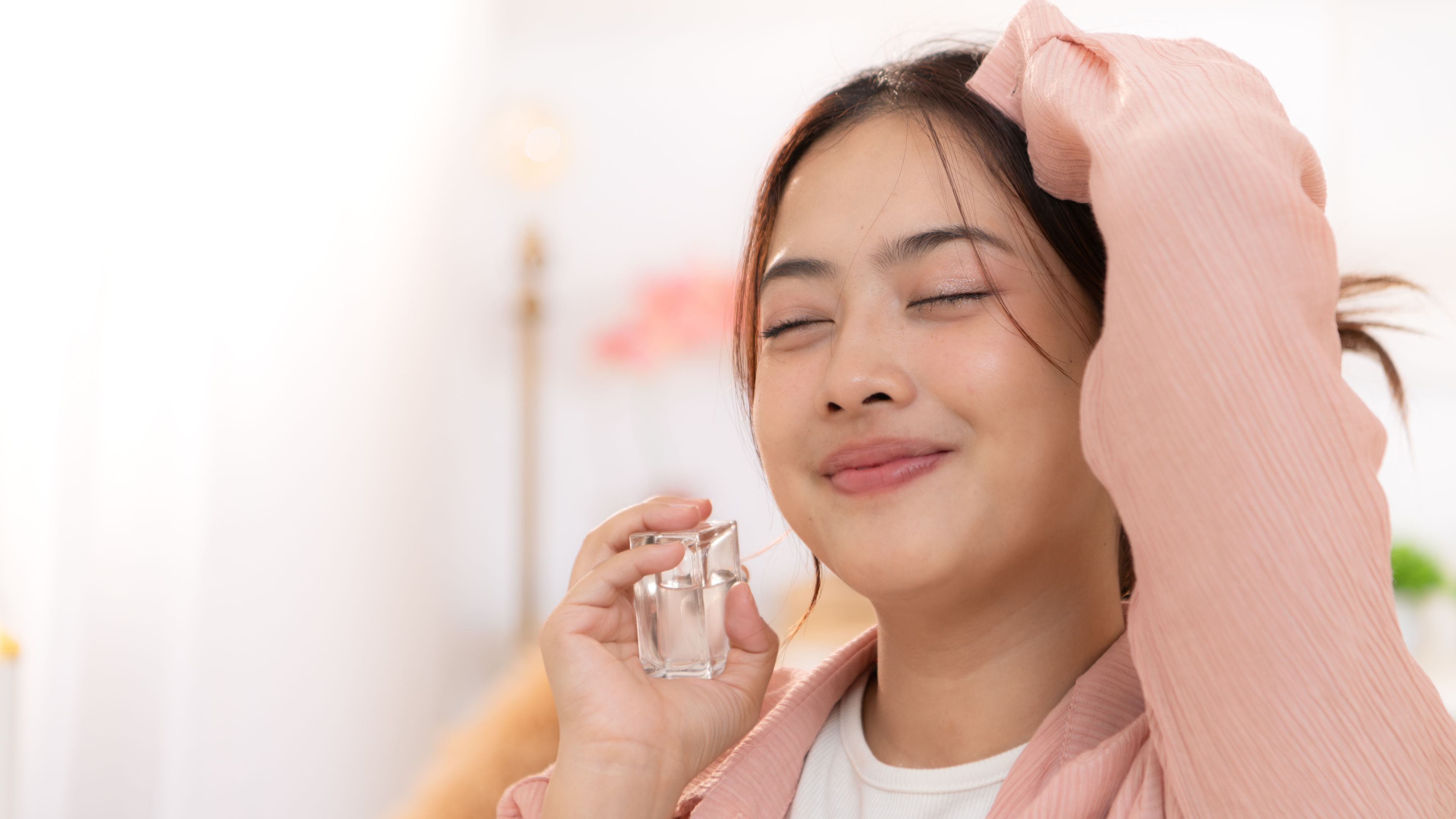 A woman using perfume