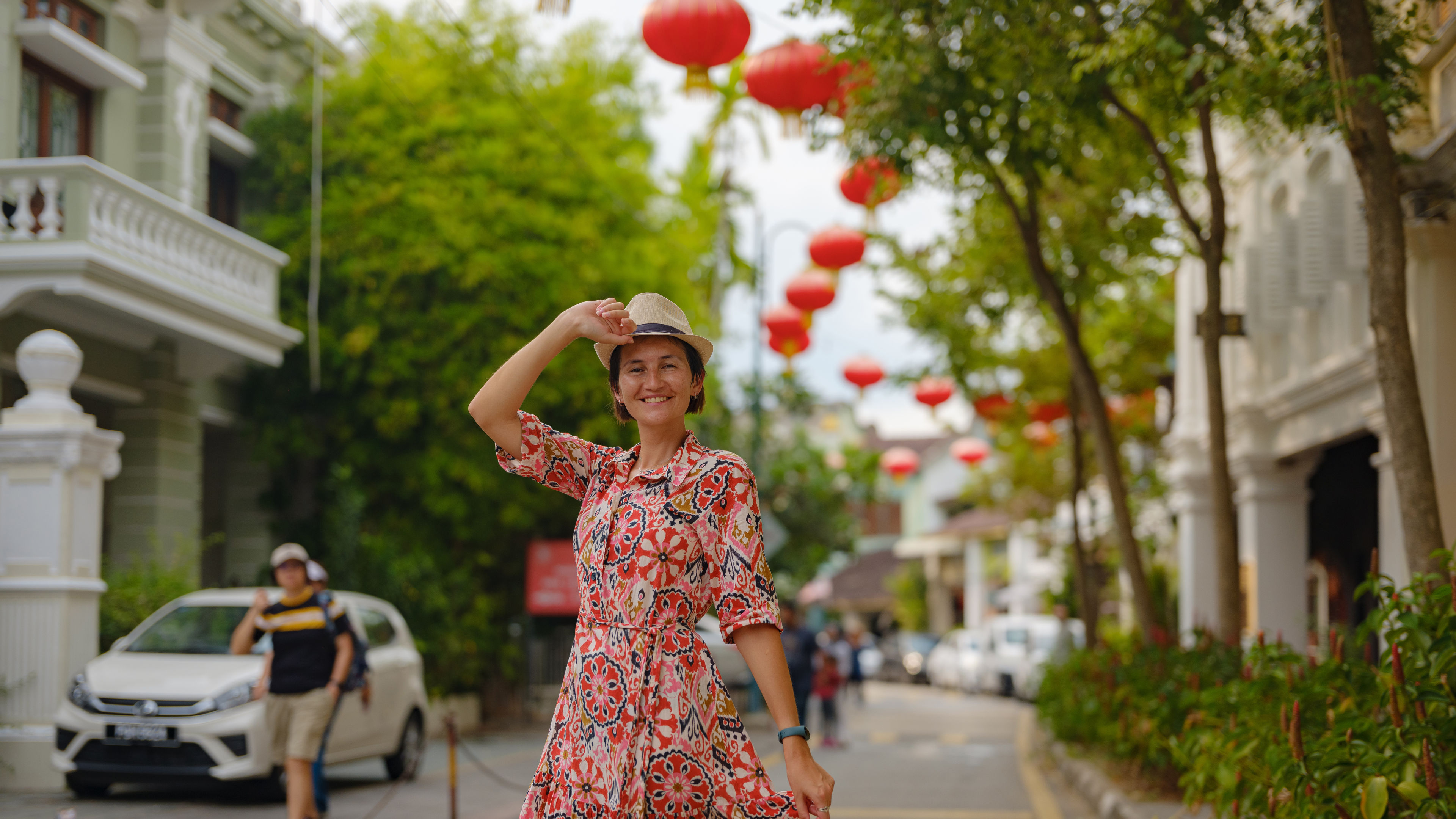 A woman with hat wearing red midi dress