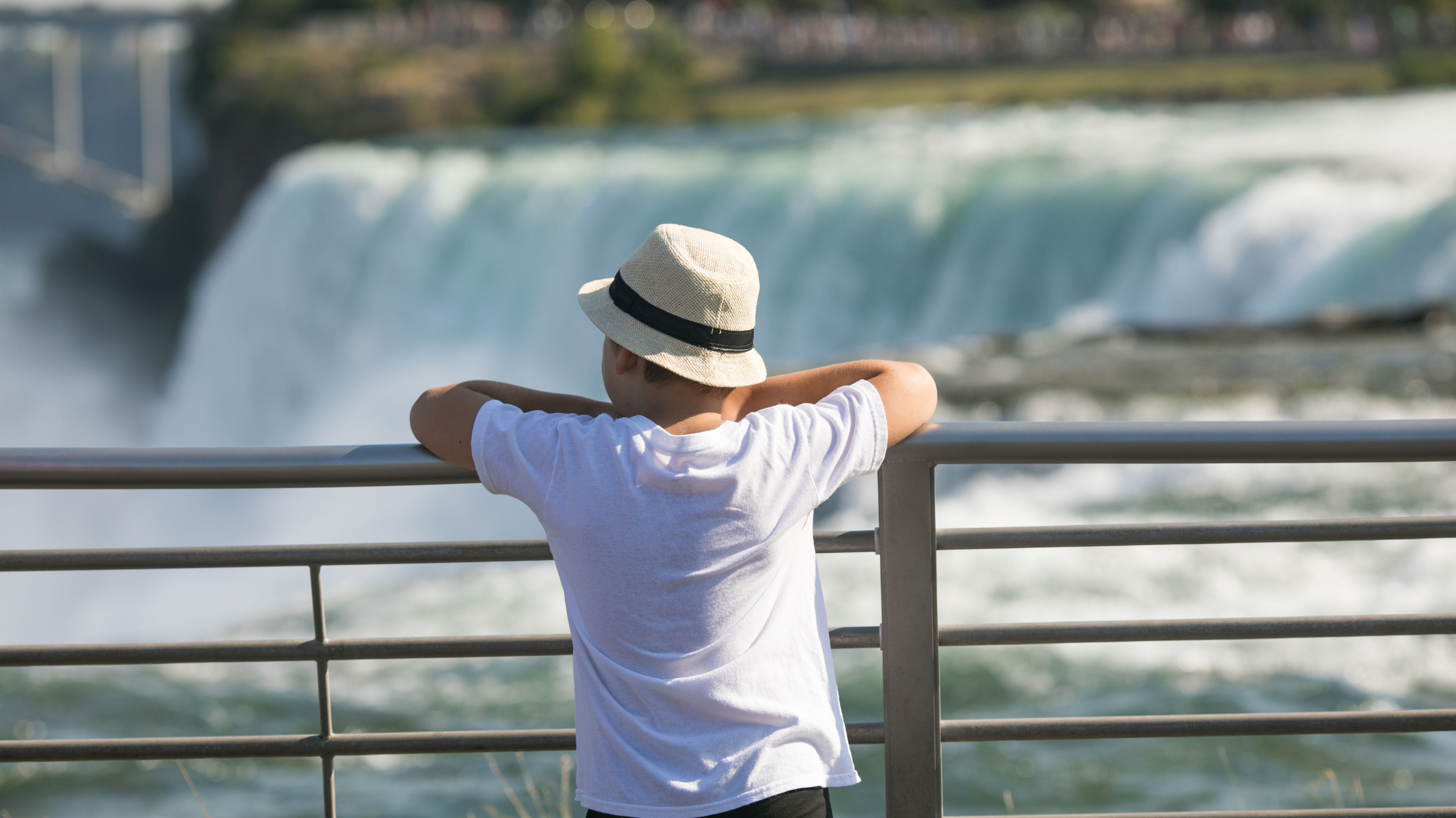 A young boy gazing at the Niagara Falls