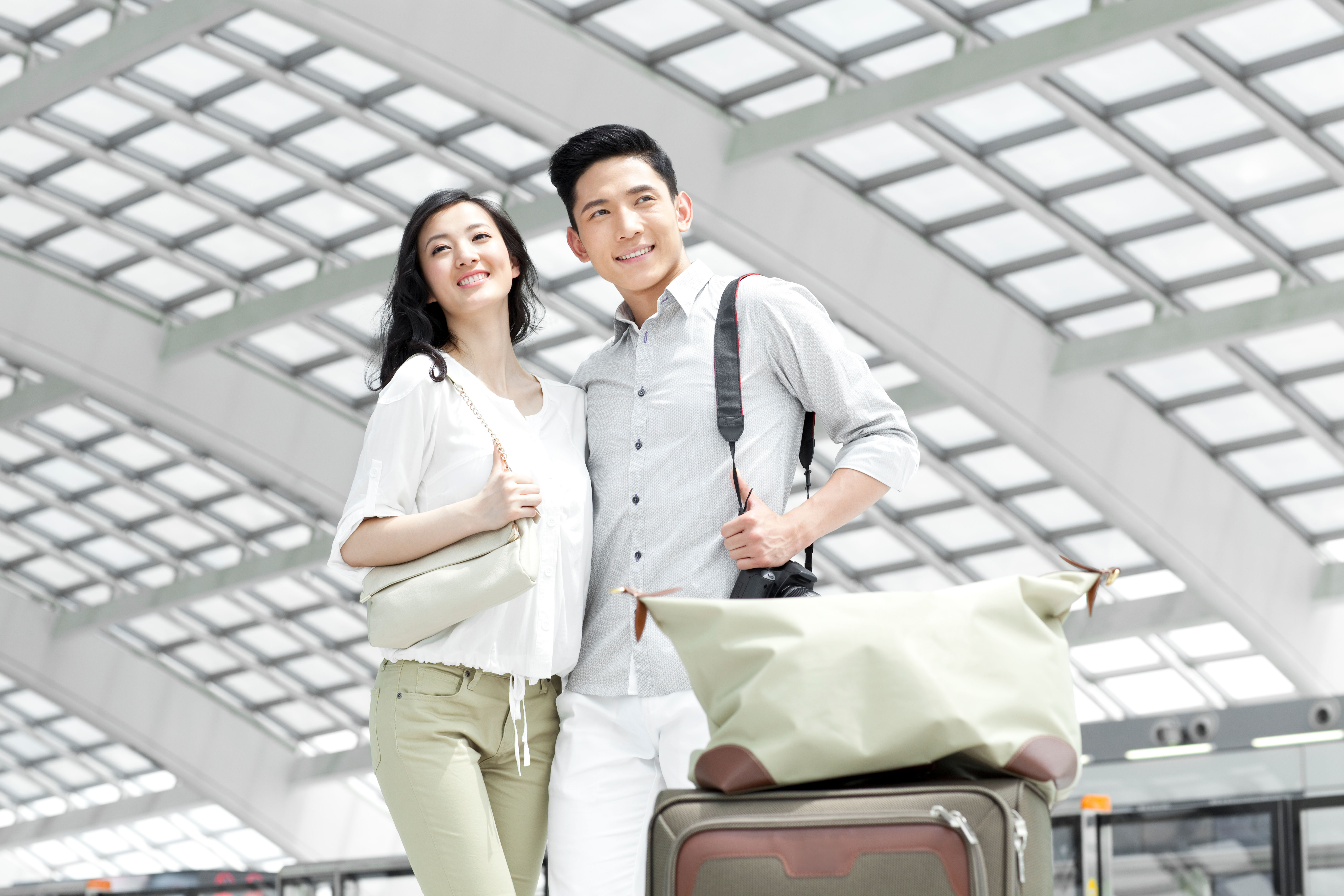 A young couple at a station ready for a trip 