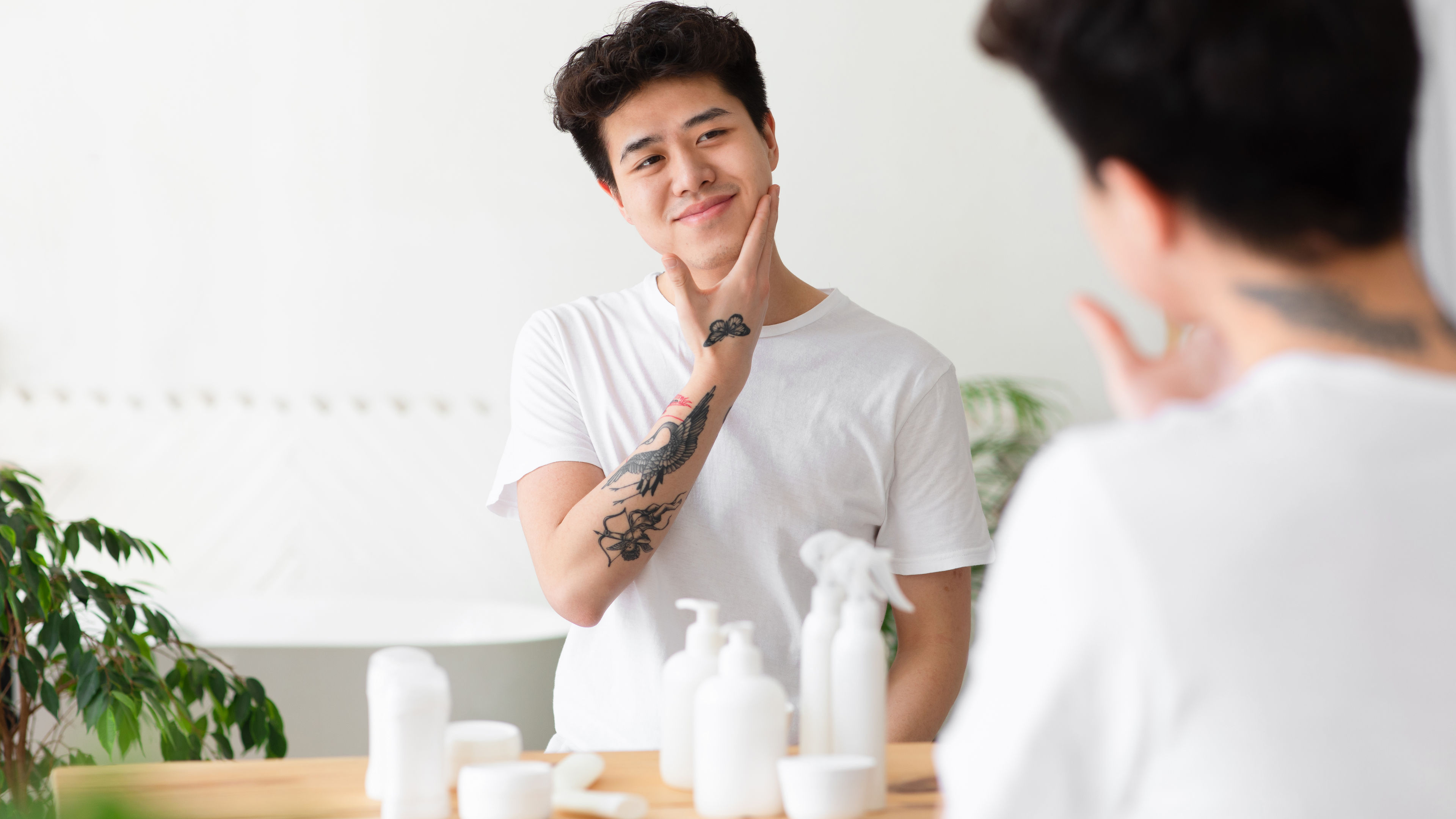 A young man looking at his own face