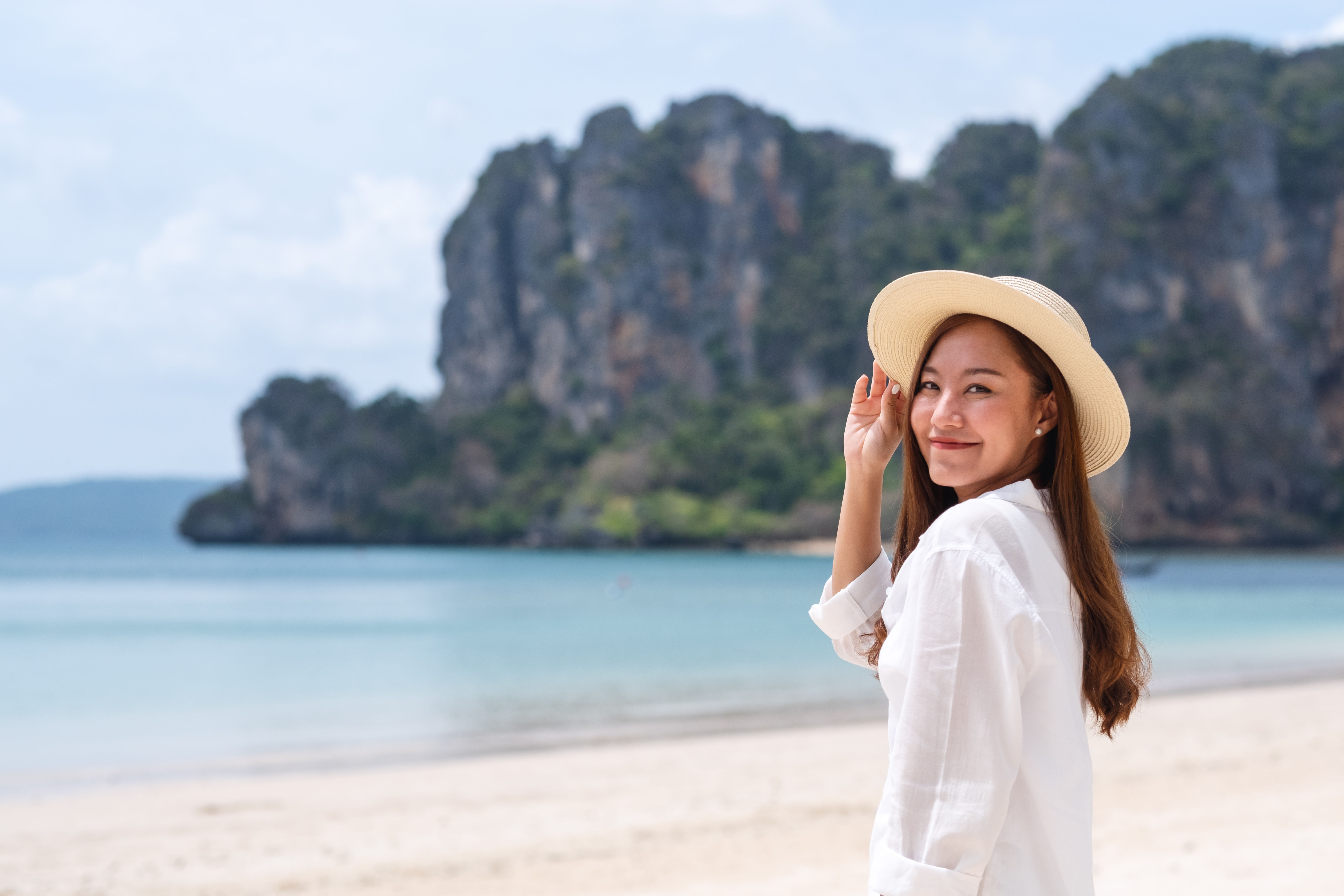 Image of an asian woman strolling in the beach 
