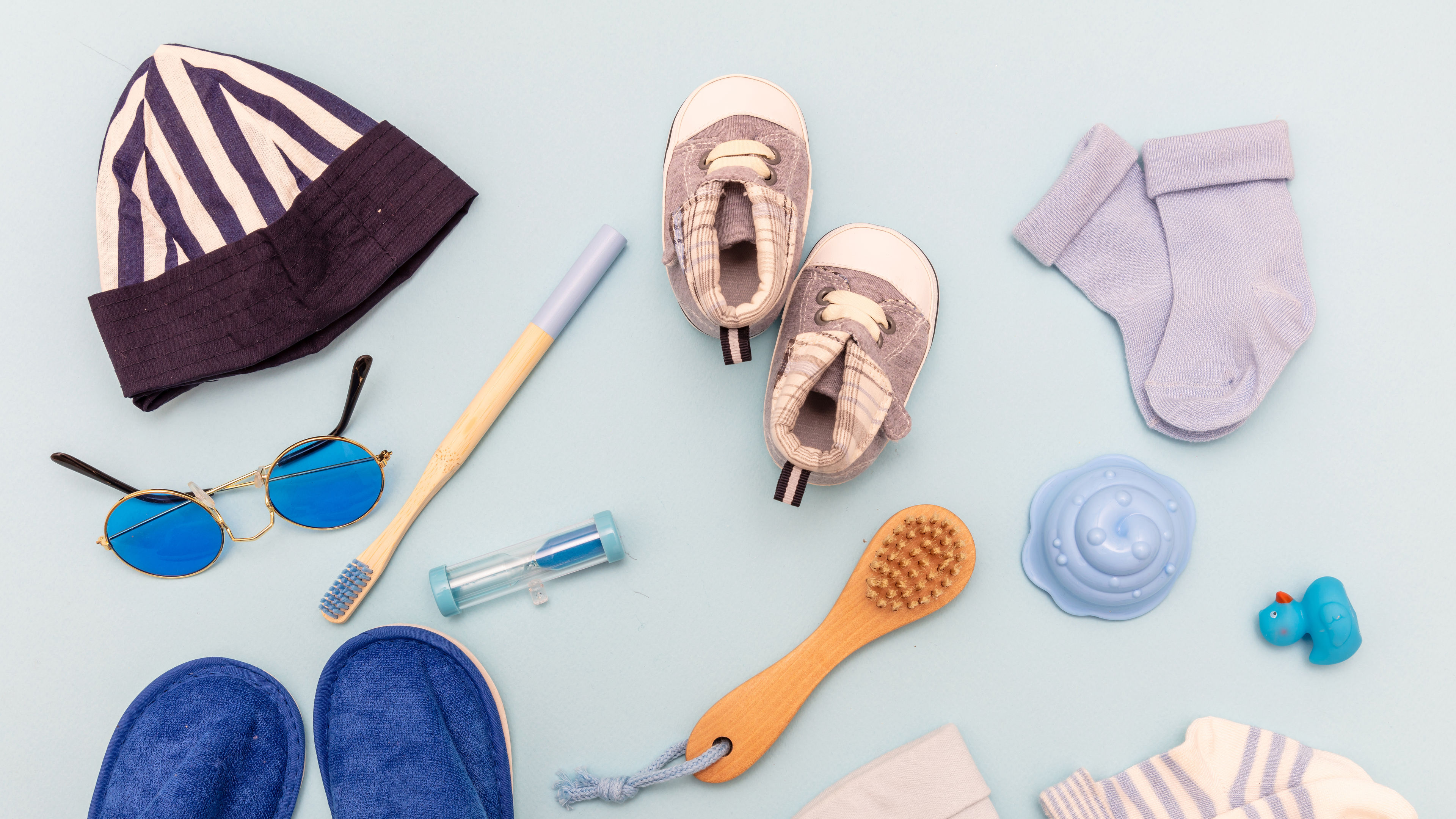 Baby boy accesories on blue background, baby shower concept 