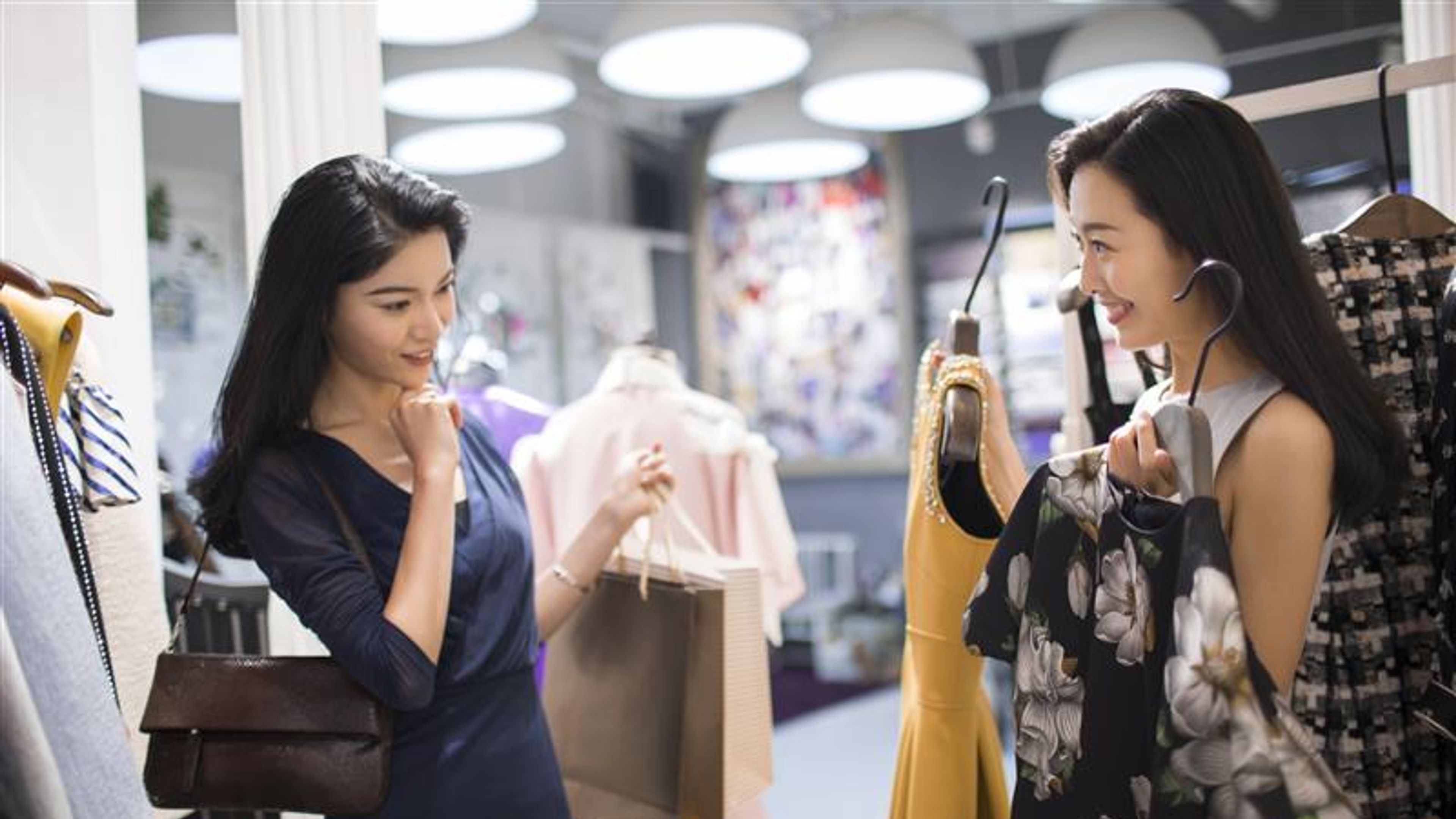 Best Chinese female friends shopping in clothing store 