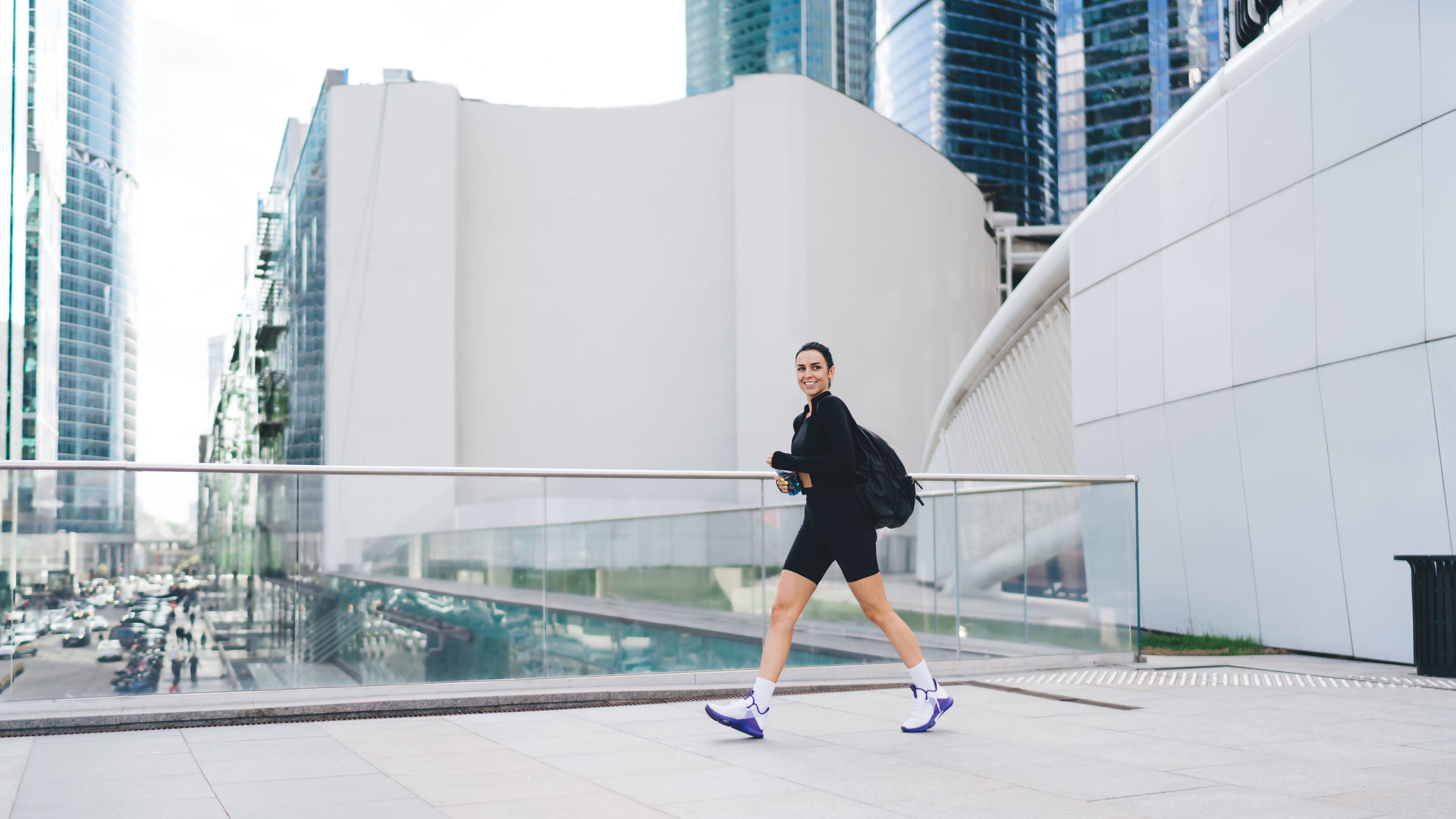Cheerful sportive woman walking on the street