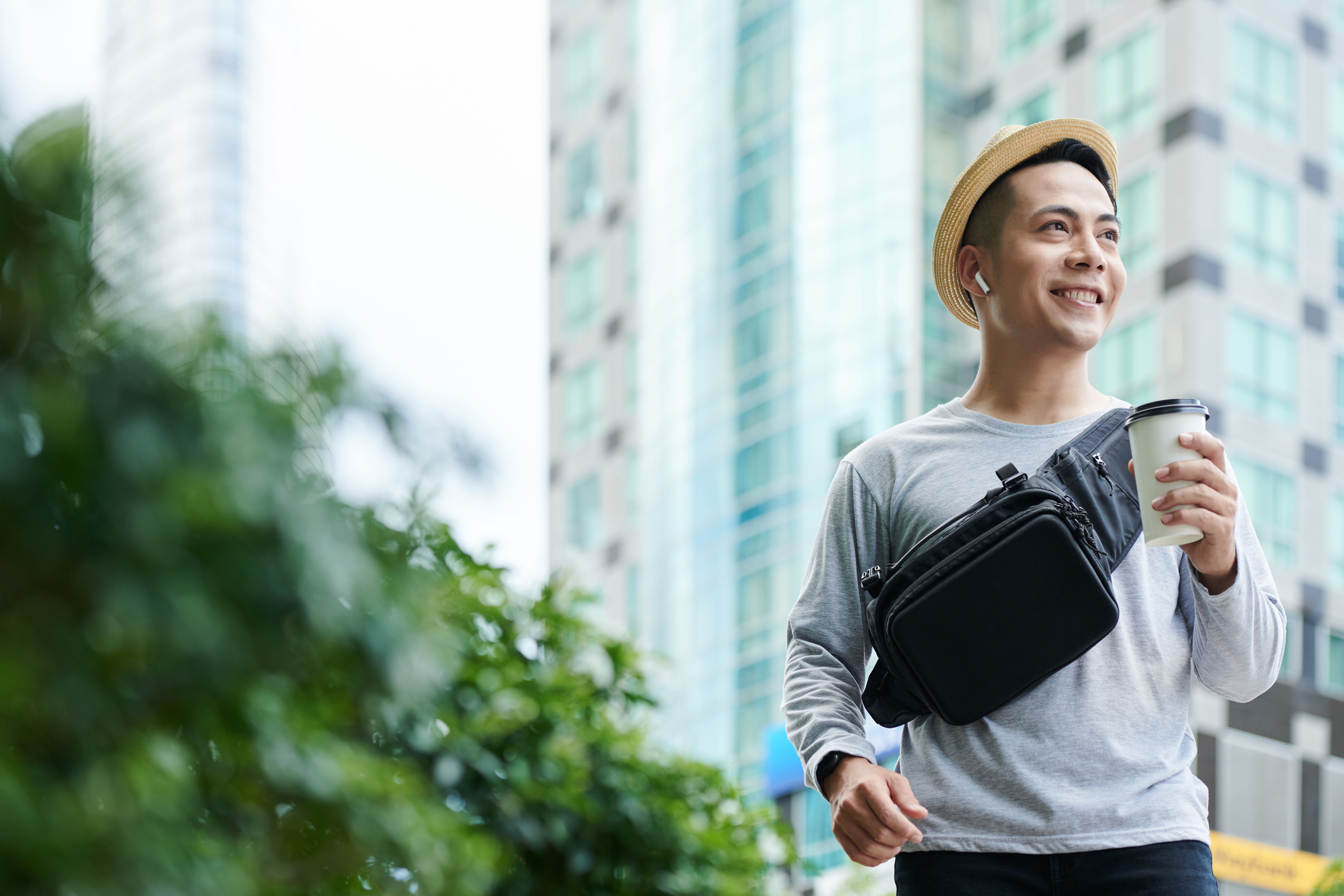 Cheerful Tourist Walking with Takeout Coffee 