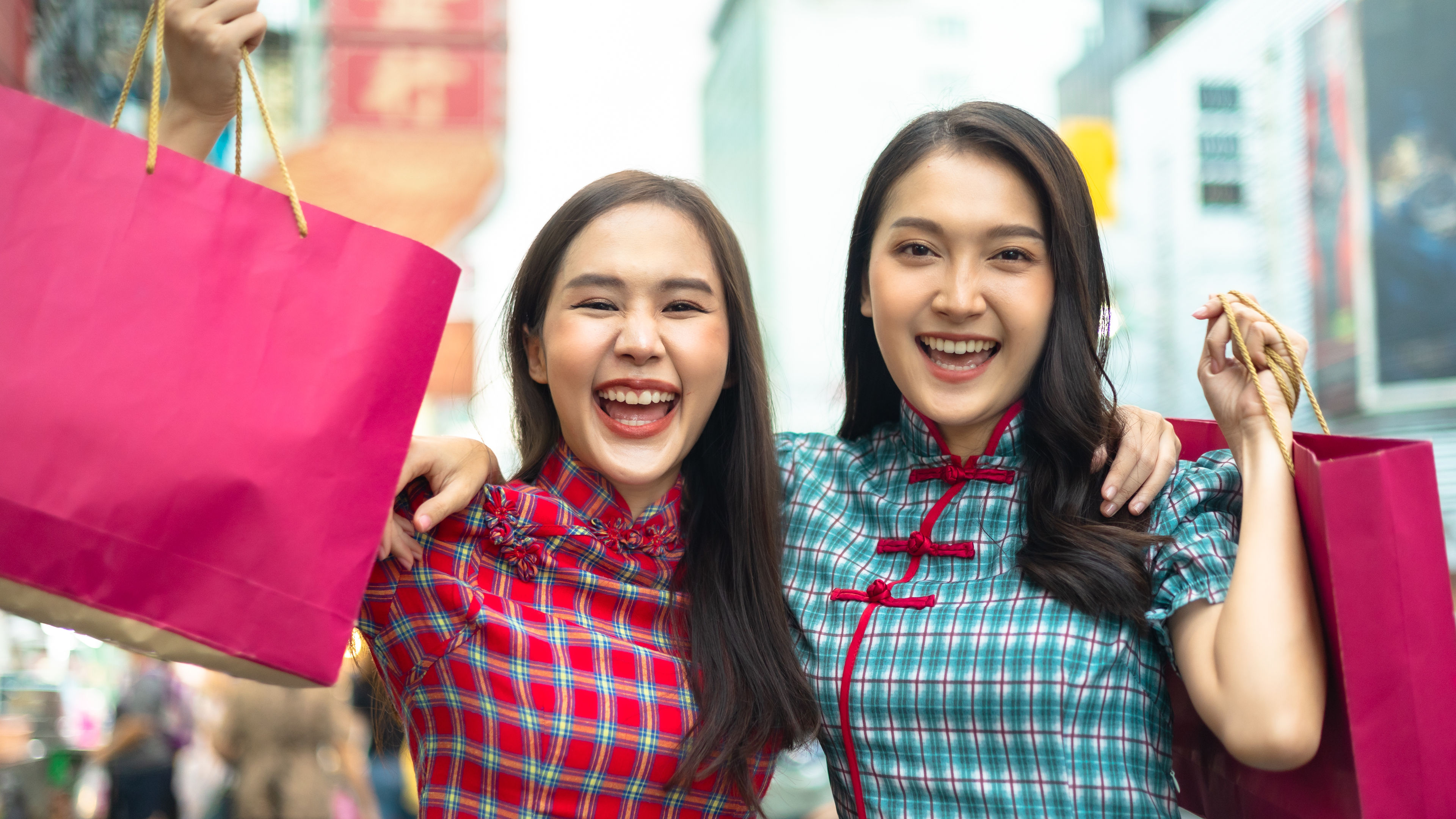 A Chinese woman enjoying her time outdoors on a bustling street.