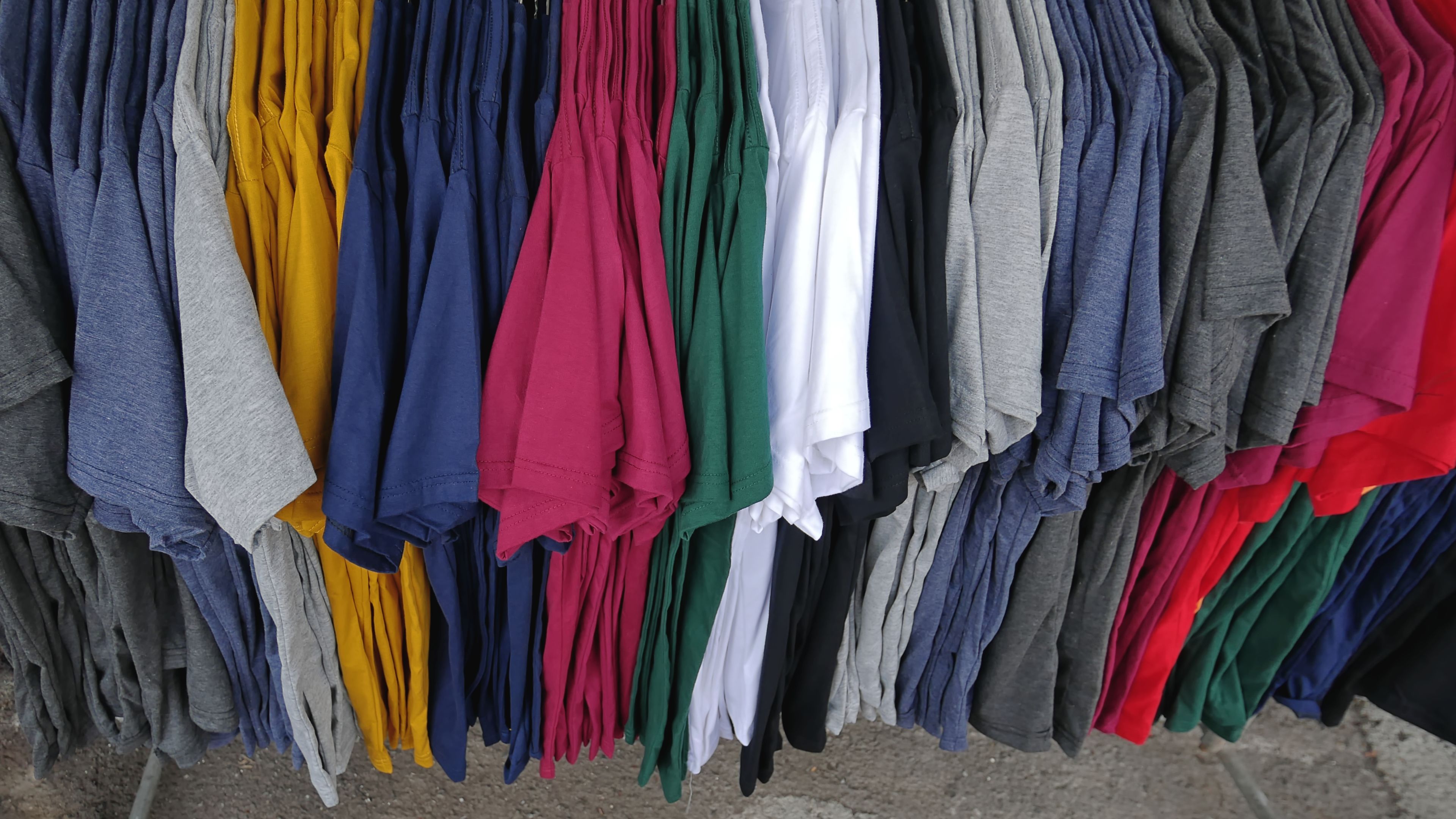 Colorful Plain Casual T-shirts hanging on the Rack 