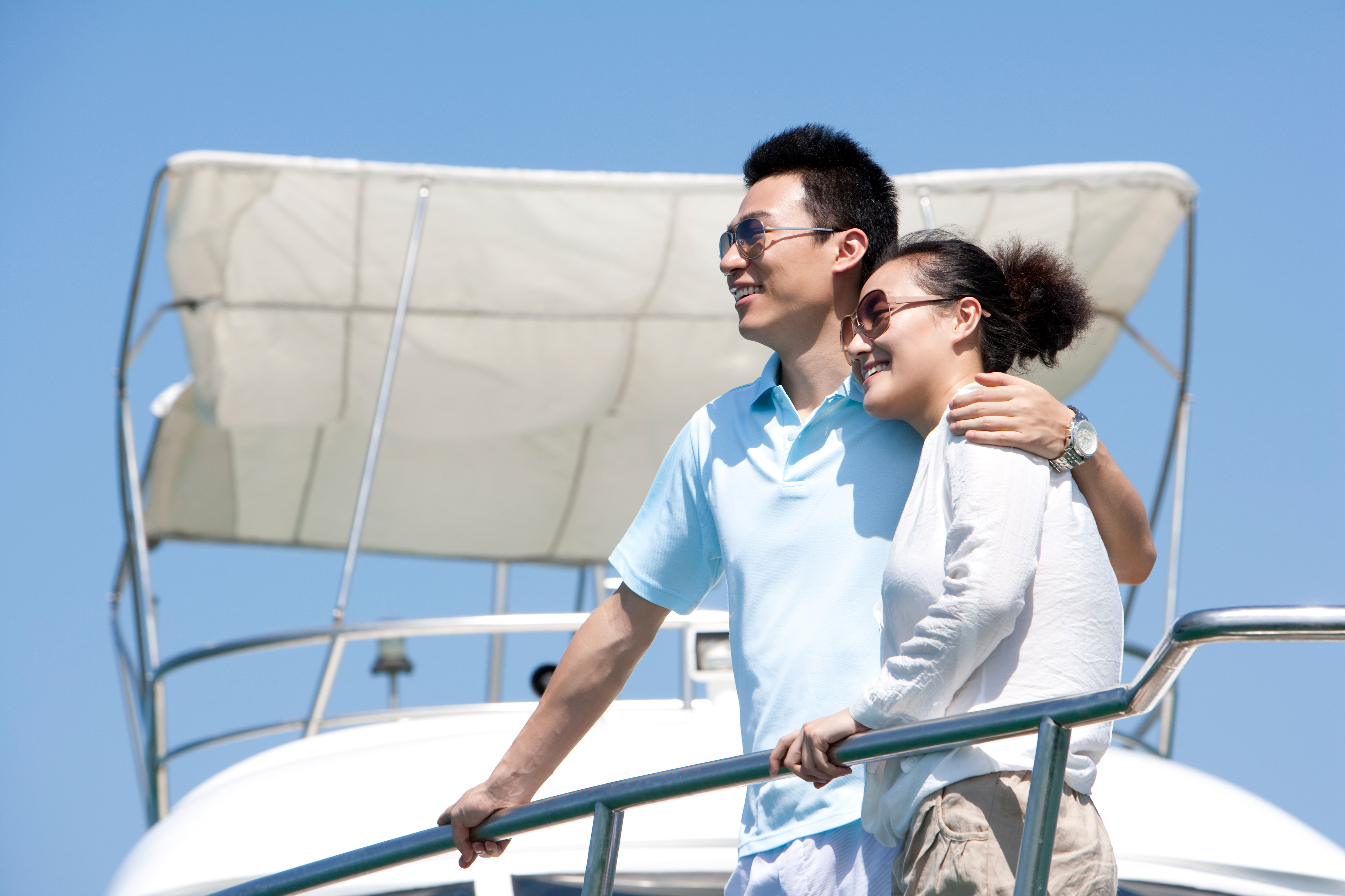 Couple smiling and sitting on a boat