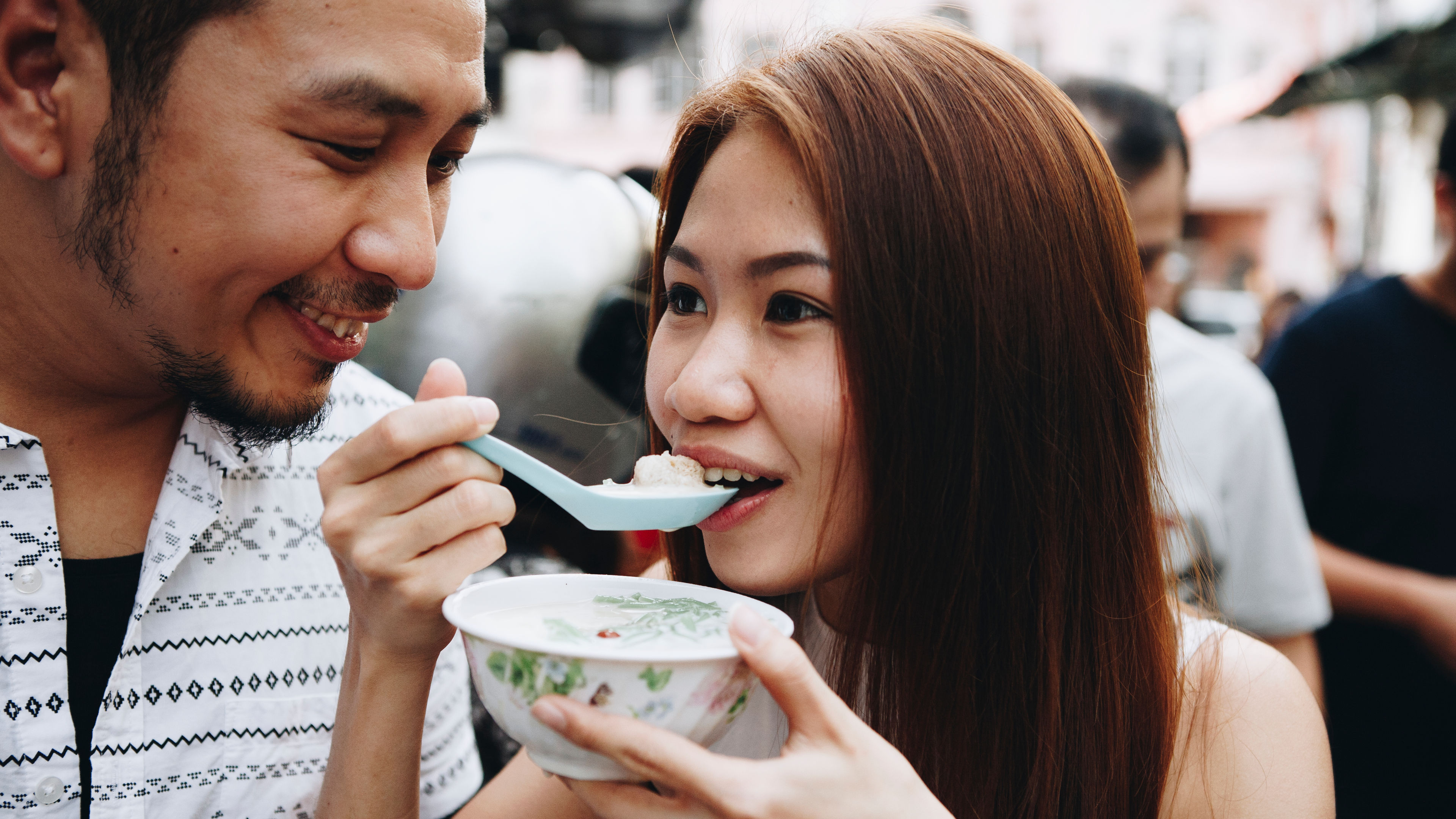 Couple tasting food 