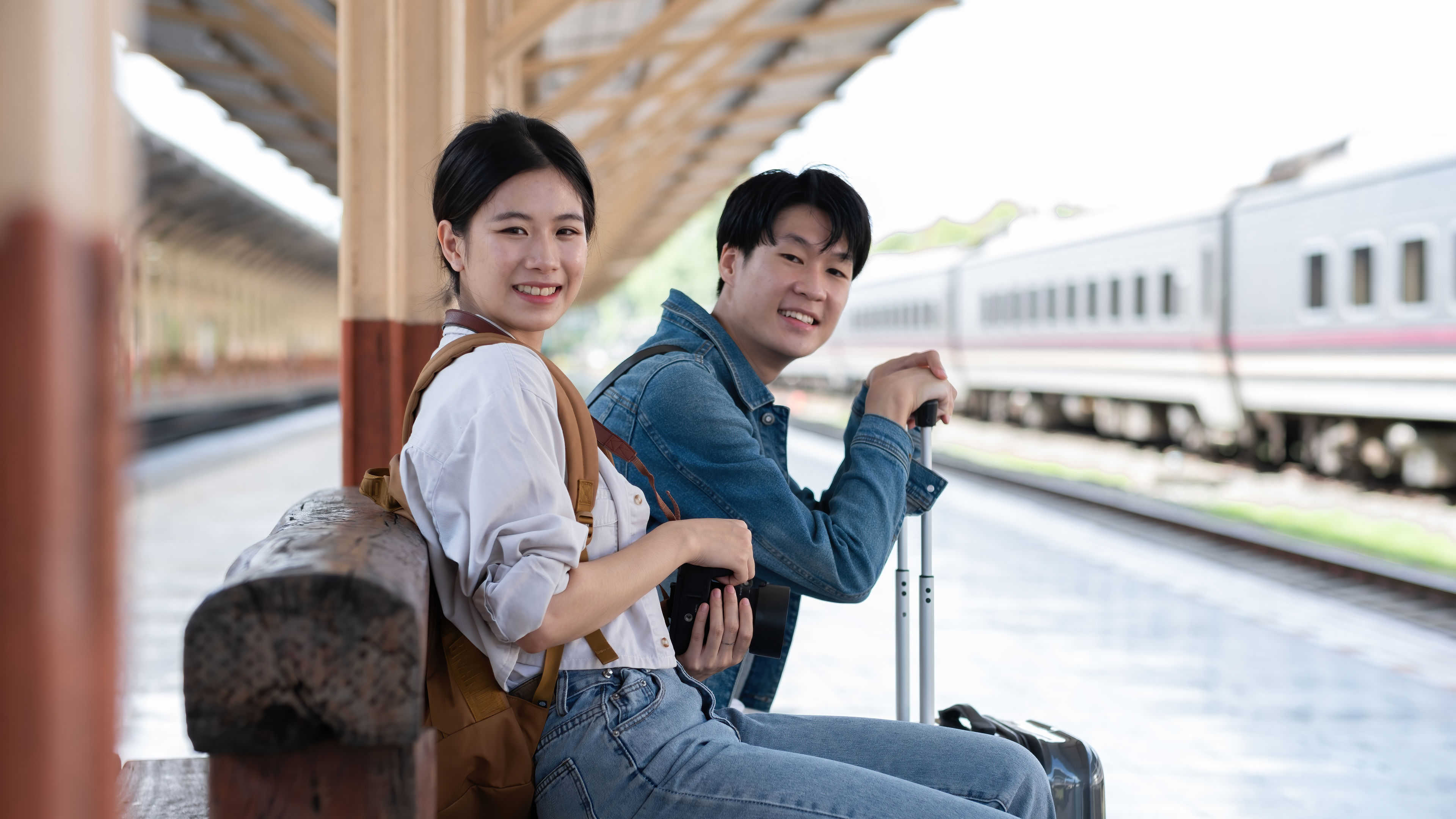 Couple waiting for train