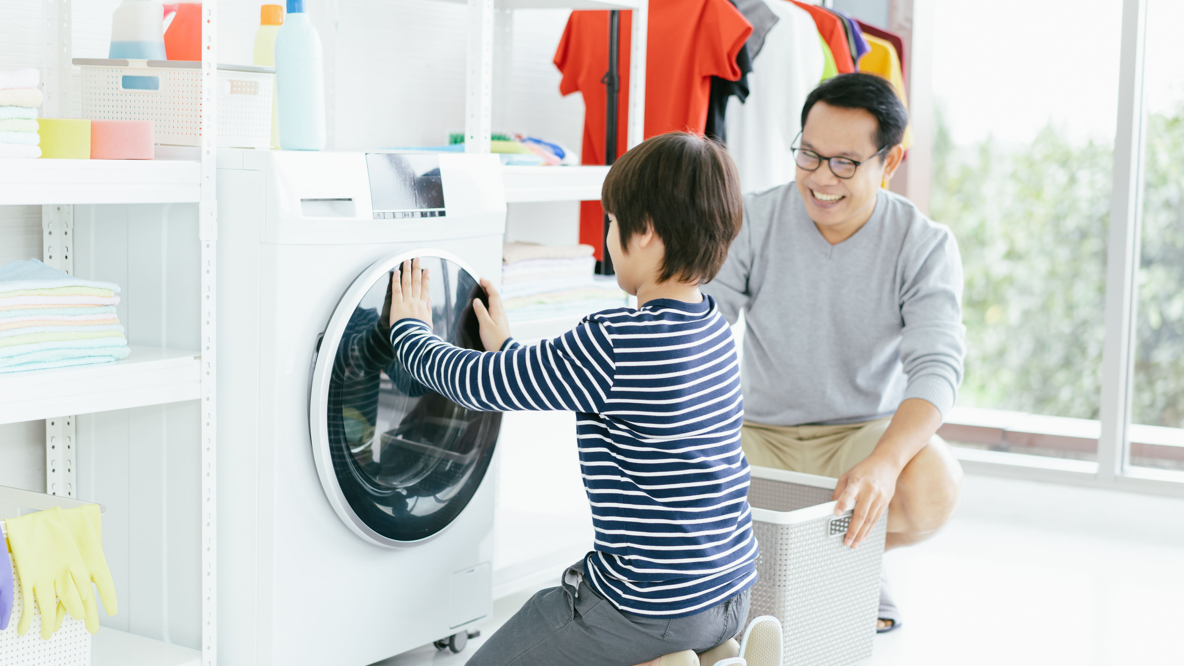 Father and son in the laundry load