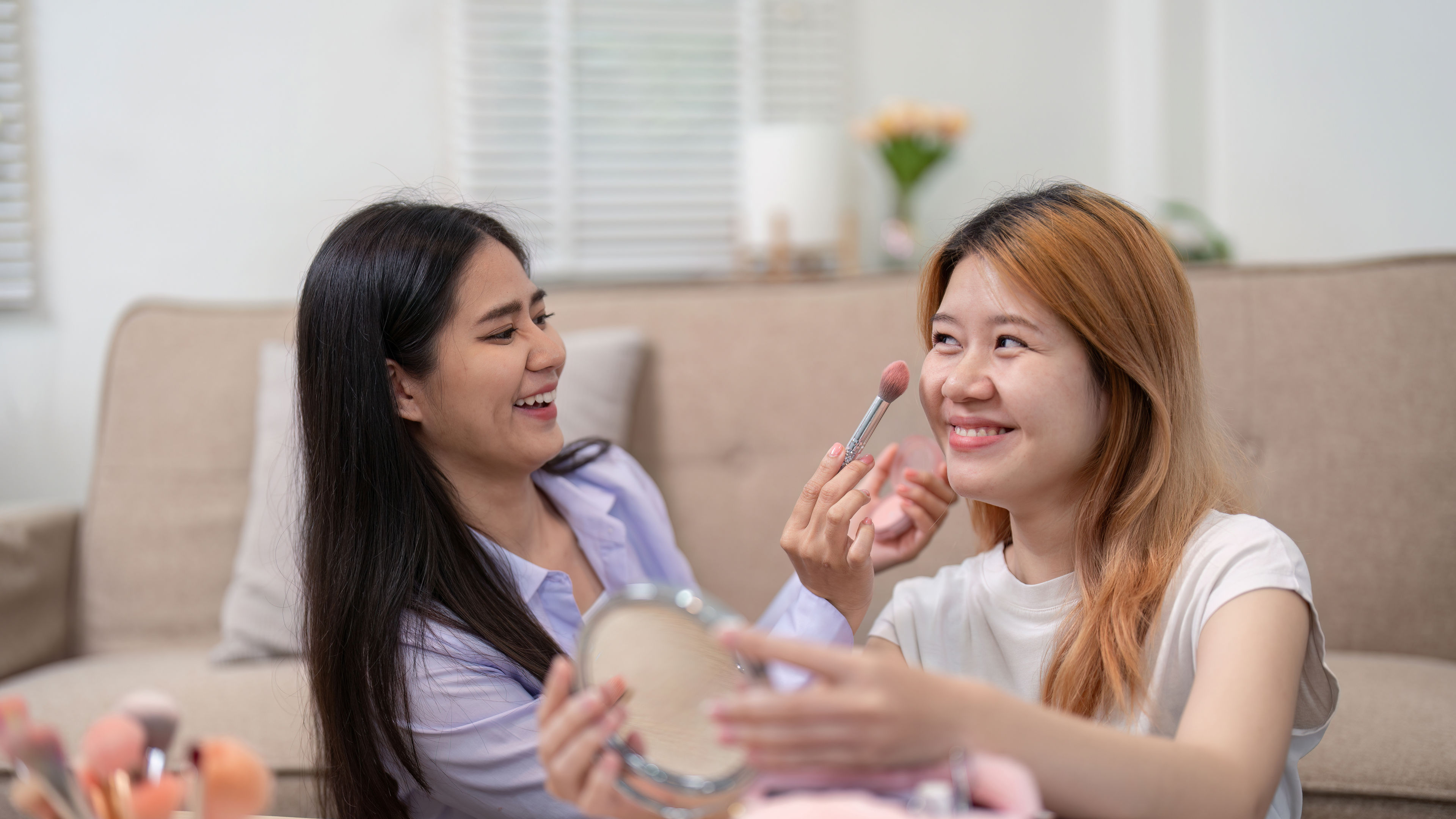 Friends applying a mask