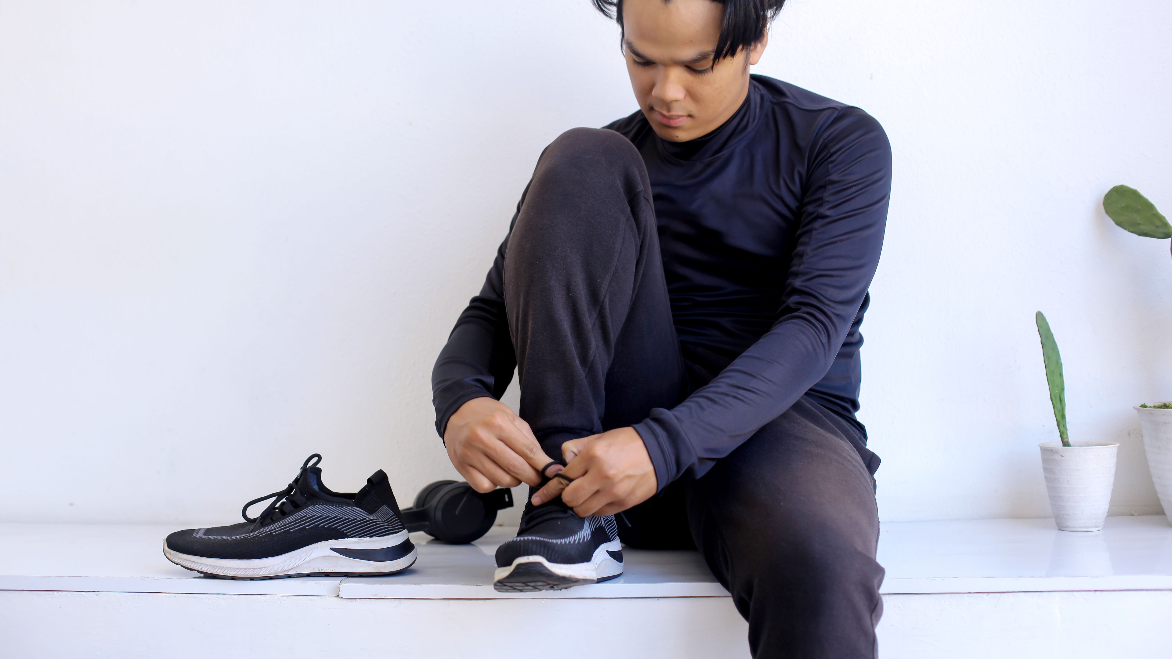 Young Asian Man Tying Shoes and Getting Ready To Workout 