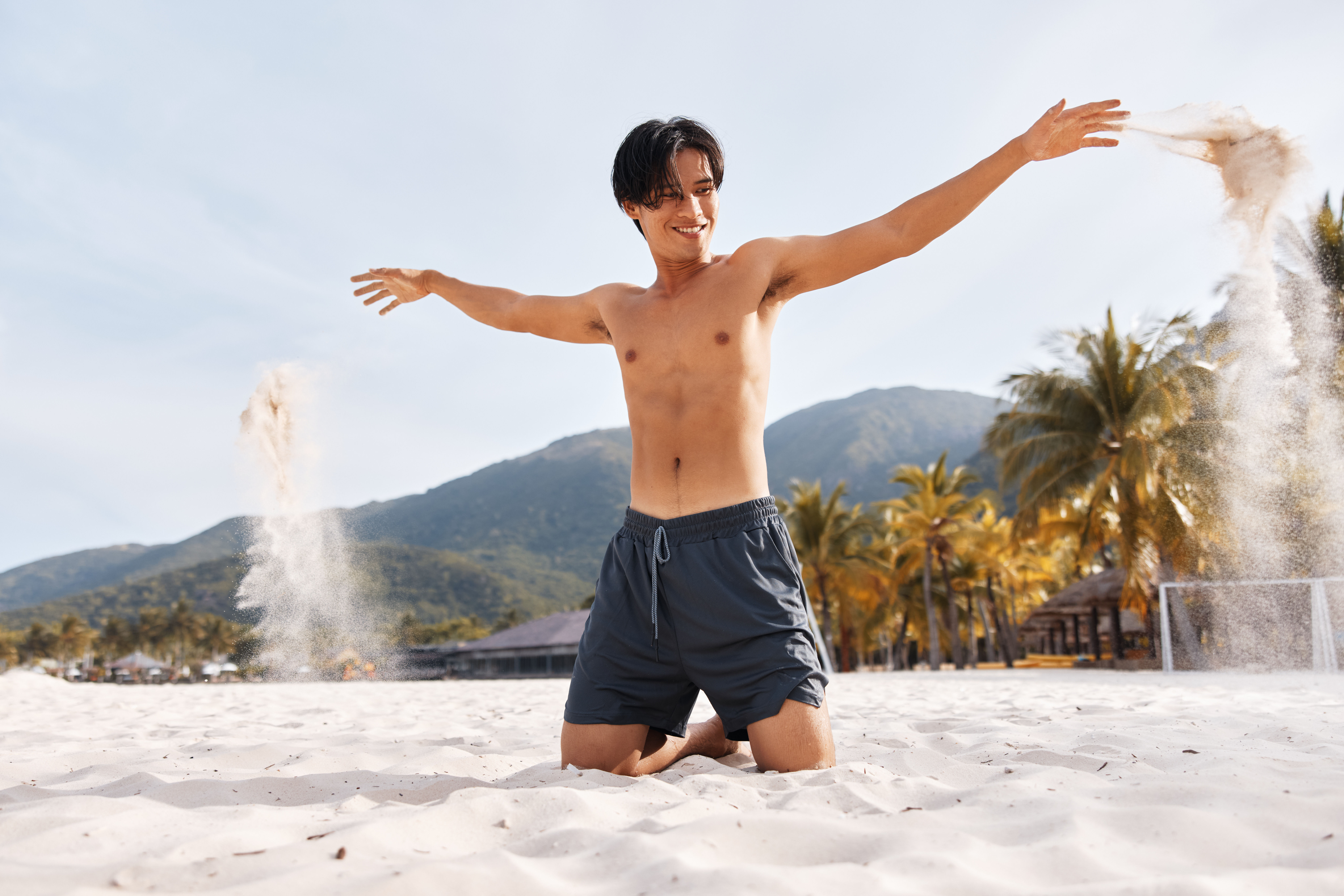 Muscular asian man in a beach 
