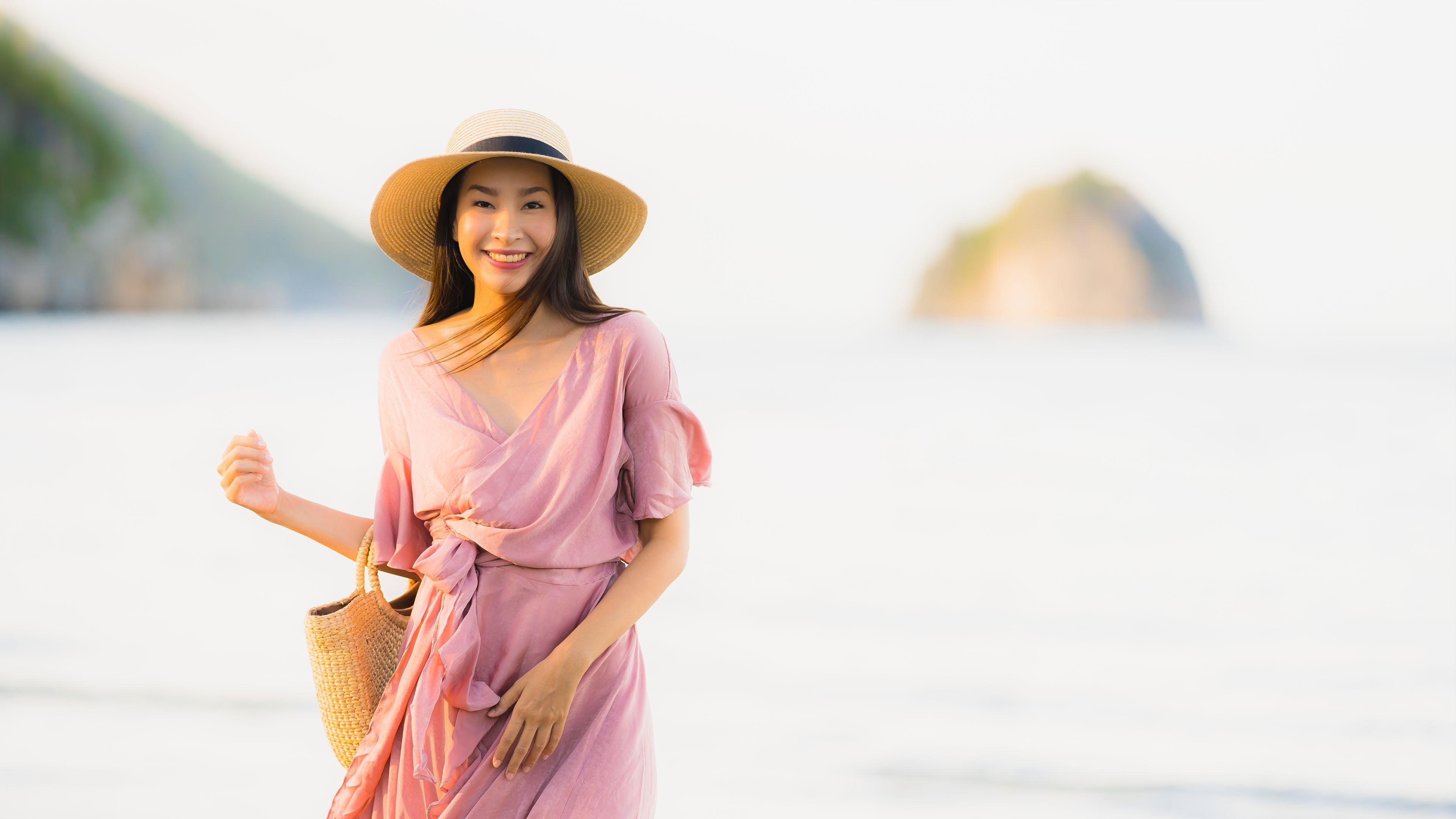 Portrait young asian woman smile happy around beach sea ocean with coconut palm tree for travel in holiday vacation.