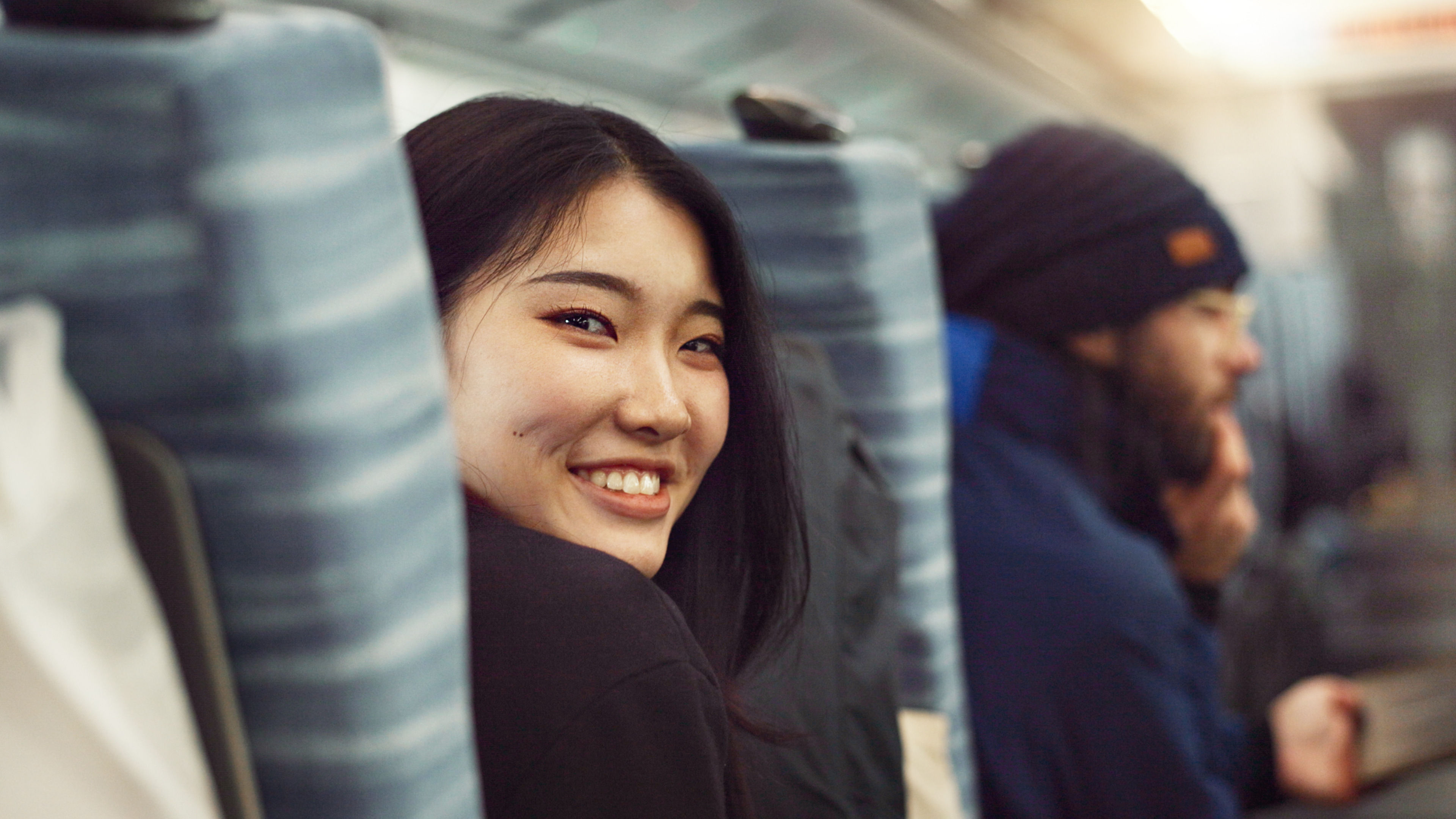 Smile, face and young Asian woman on a train for public transportation to work in the city, Happy