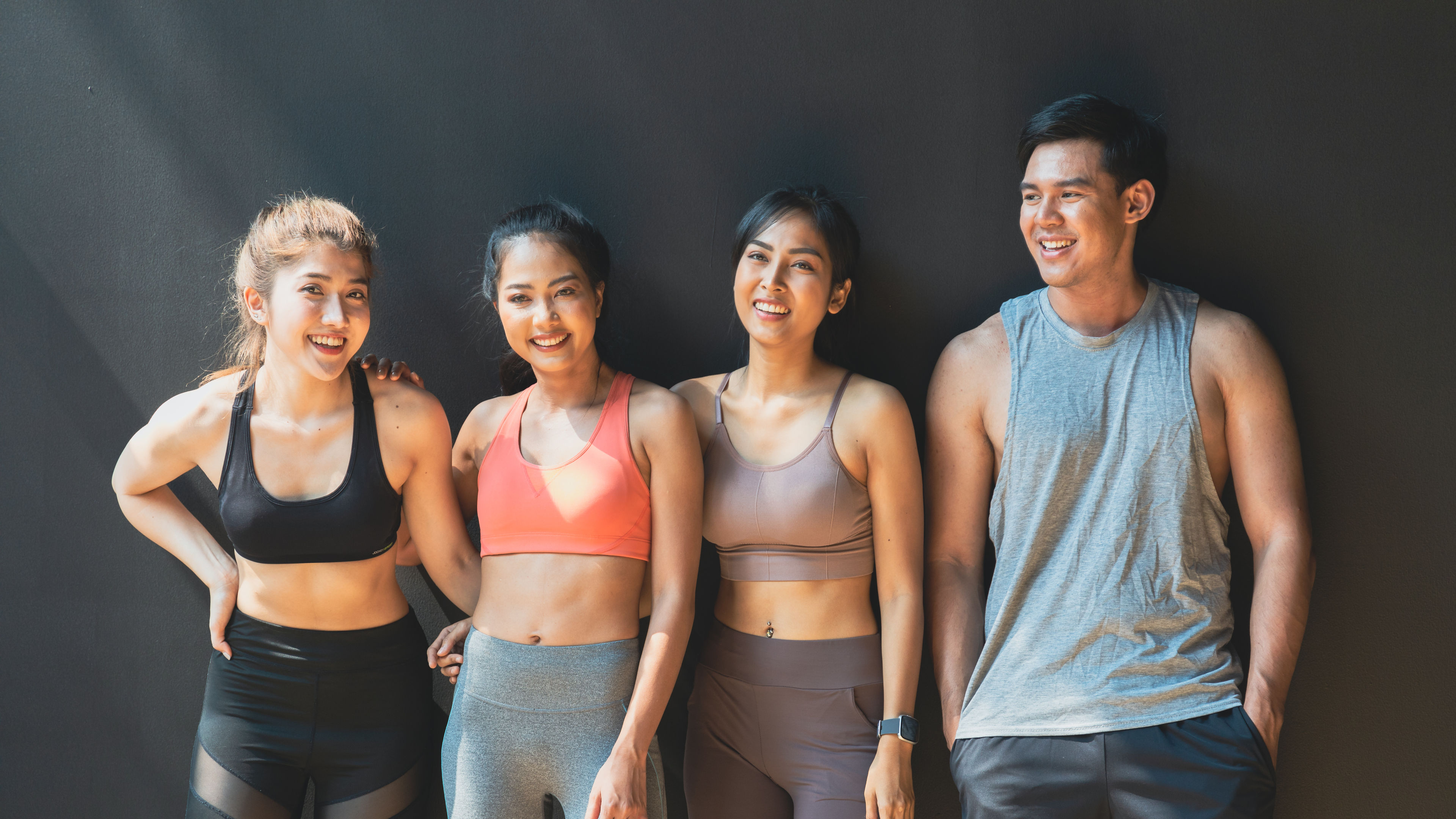 Smiling Friends Wearing Workout Clothes 