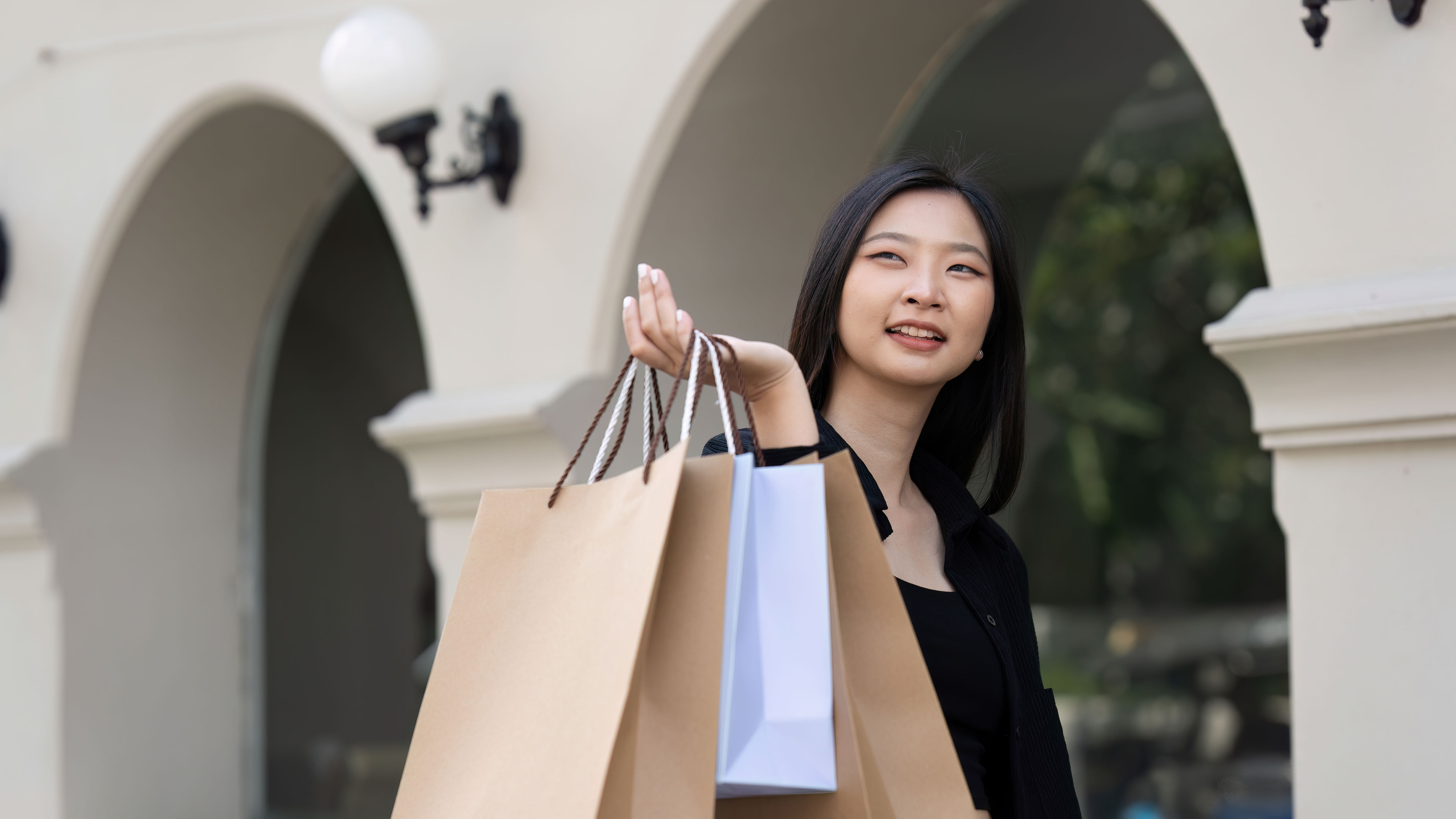 A young Asian woman in stylish shopping fashion, radiating elegance and confidence