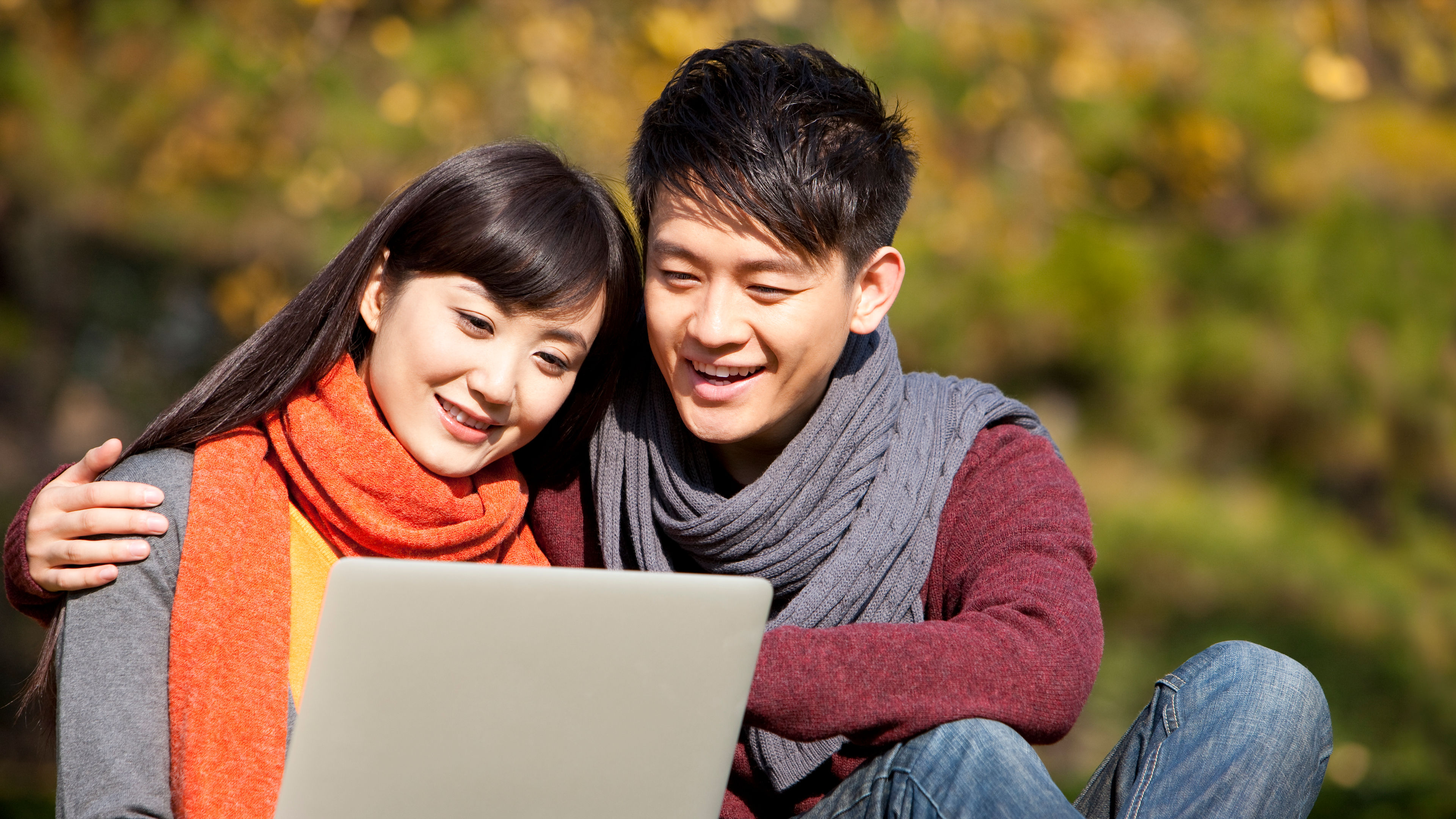 Sweet young couple sharing laptop