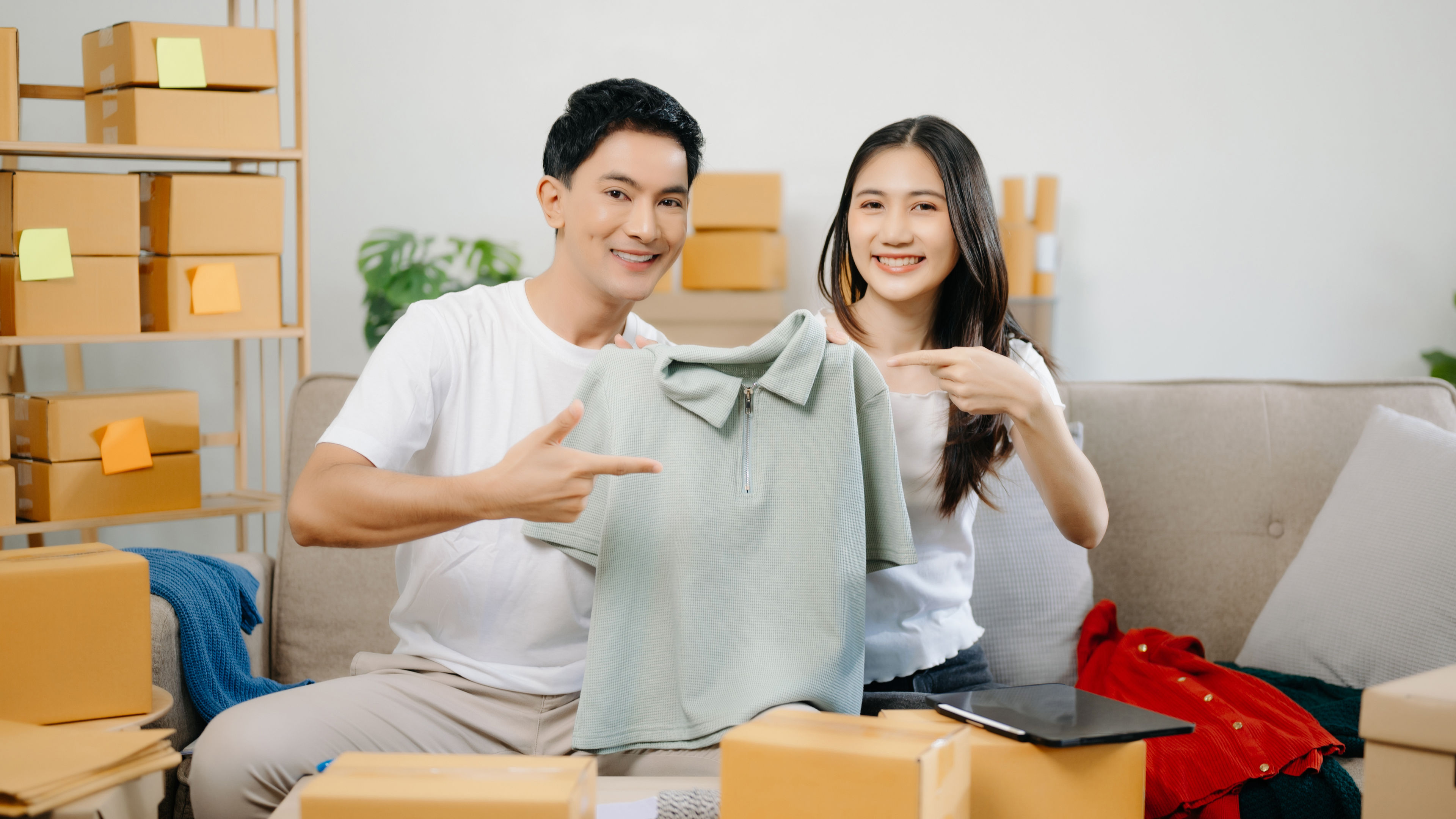 Two Asians showing clothes