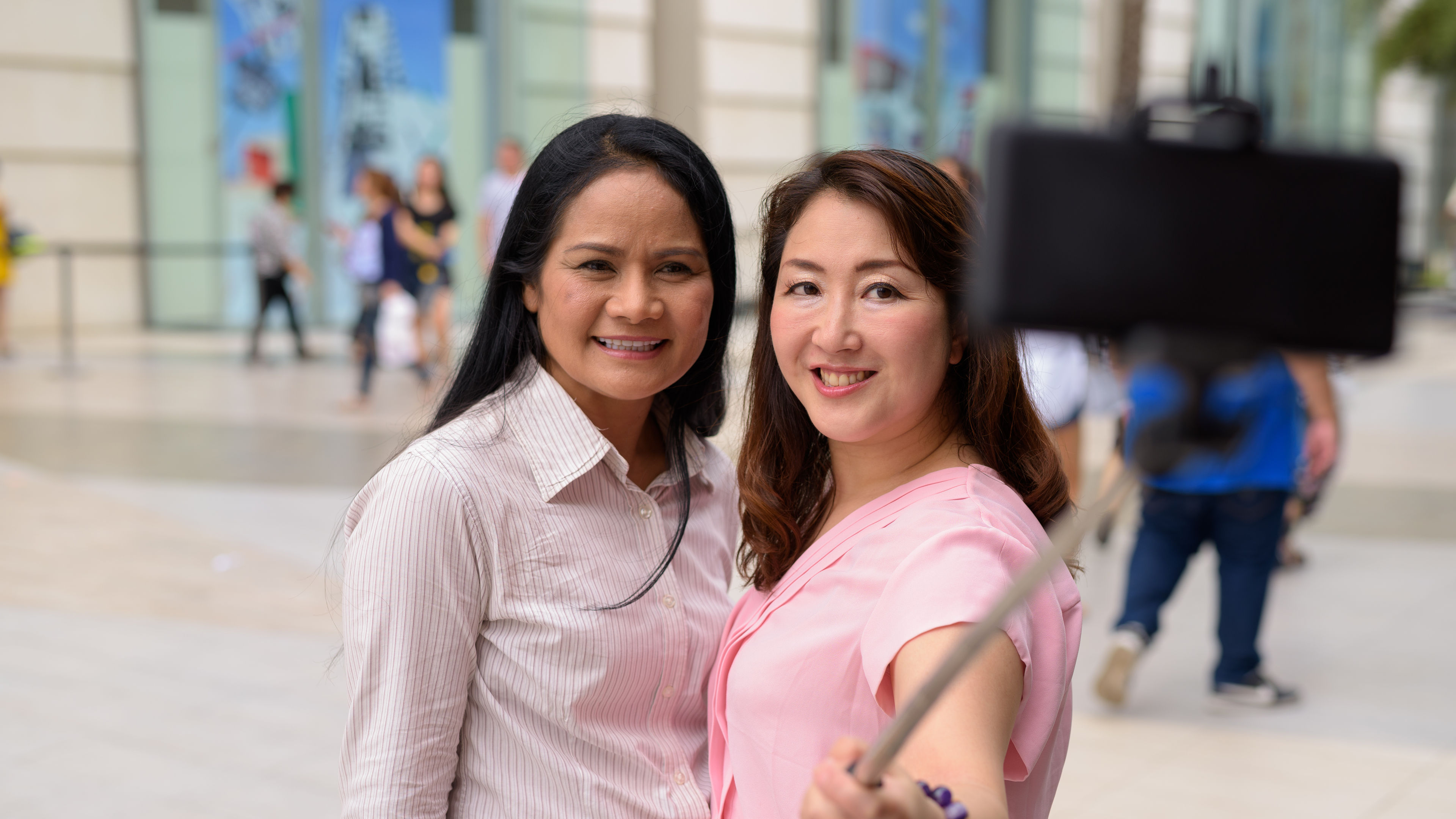 Two women are smiling while taking a selfie