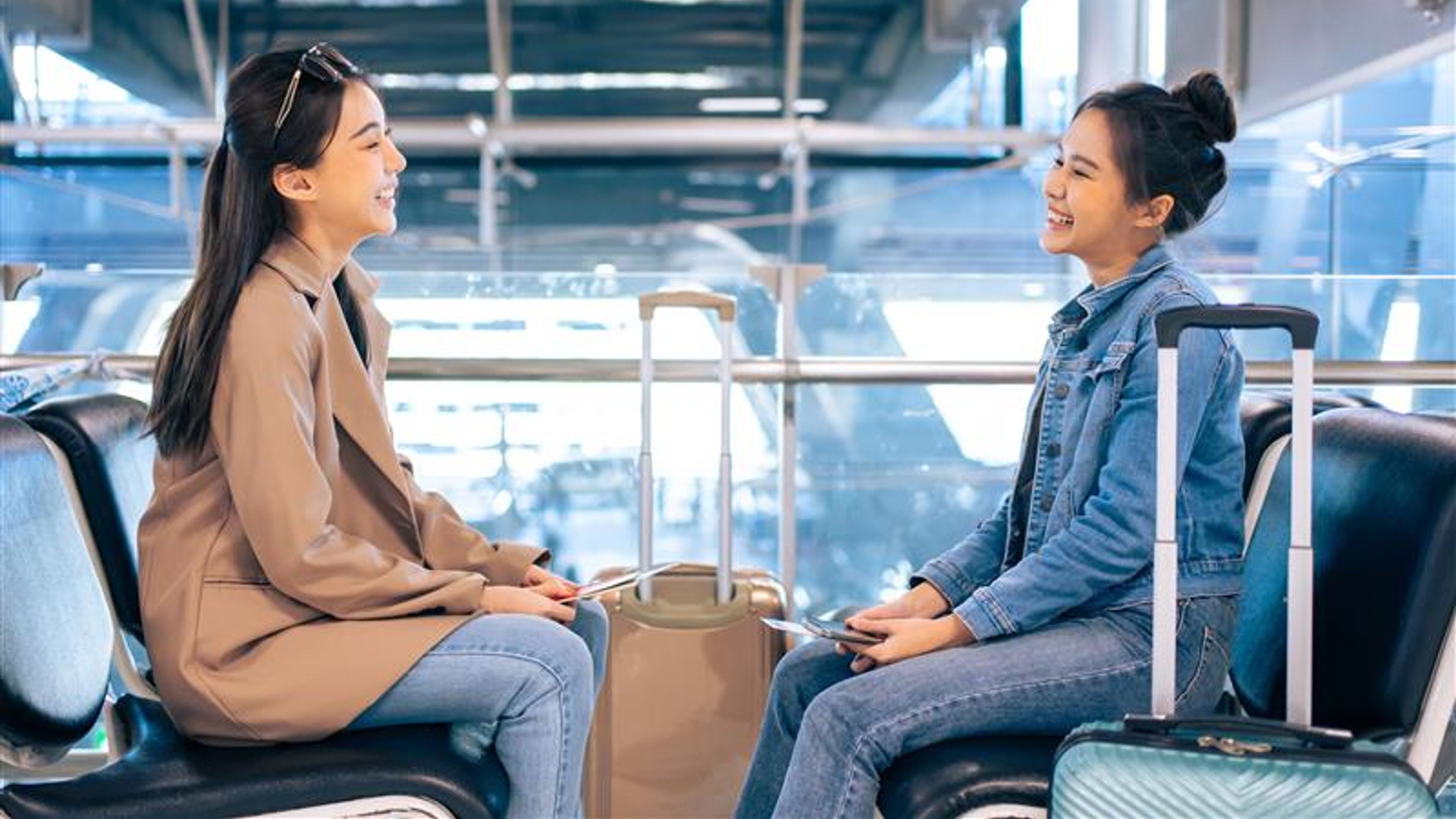 Two women talking in an airport