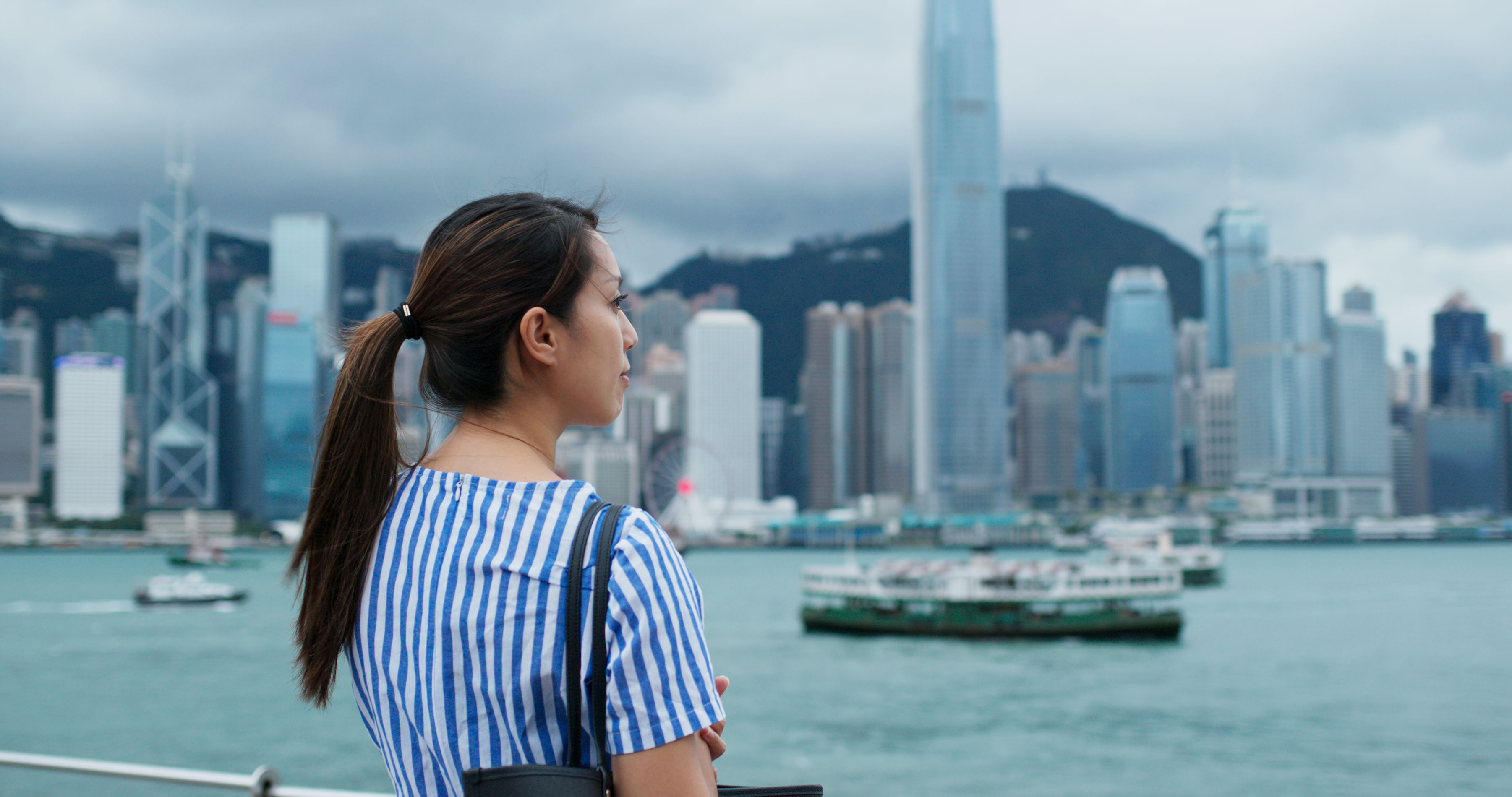 Woman look at the city view in Hong Kong 