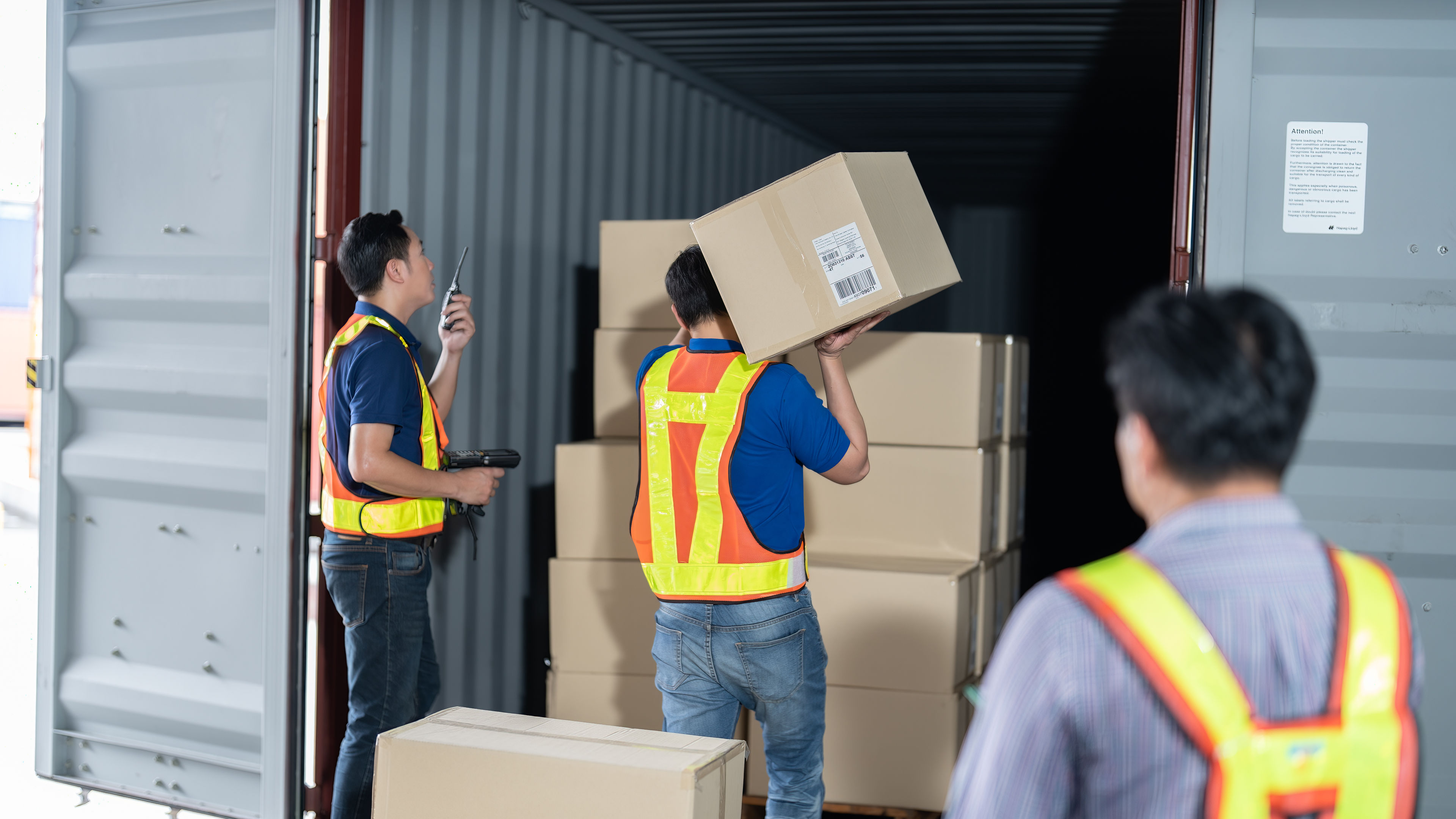 Workers open steel 40 feet container doors