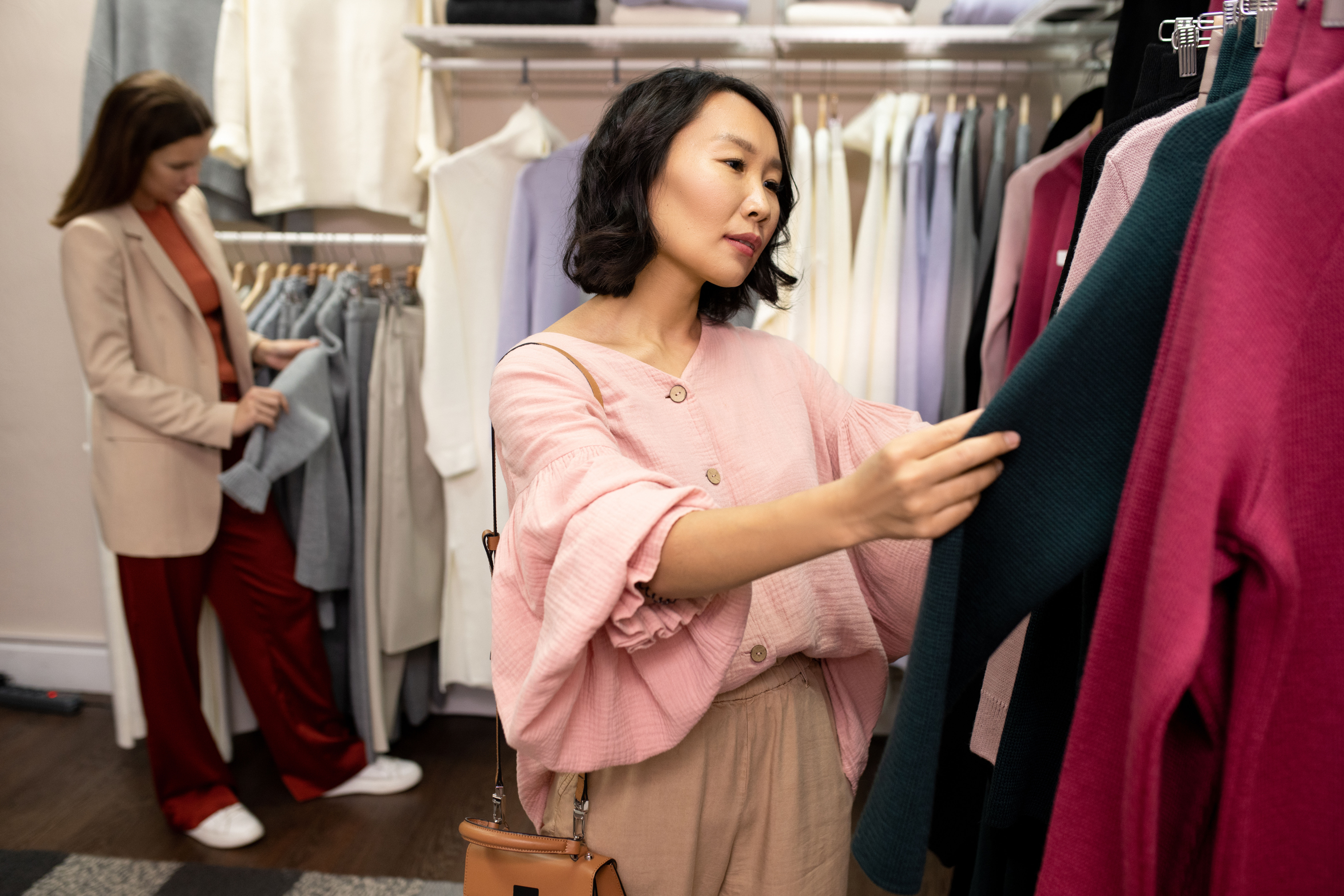 Image of an asian customer in pink shopping  