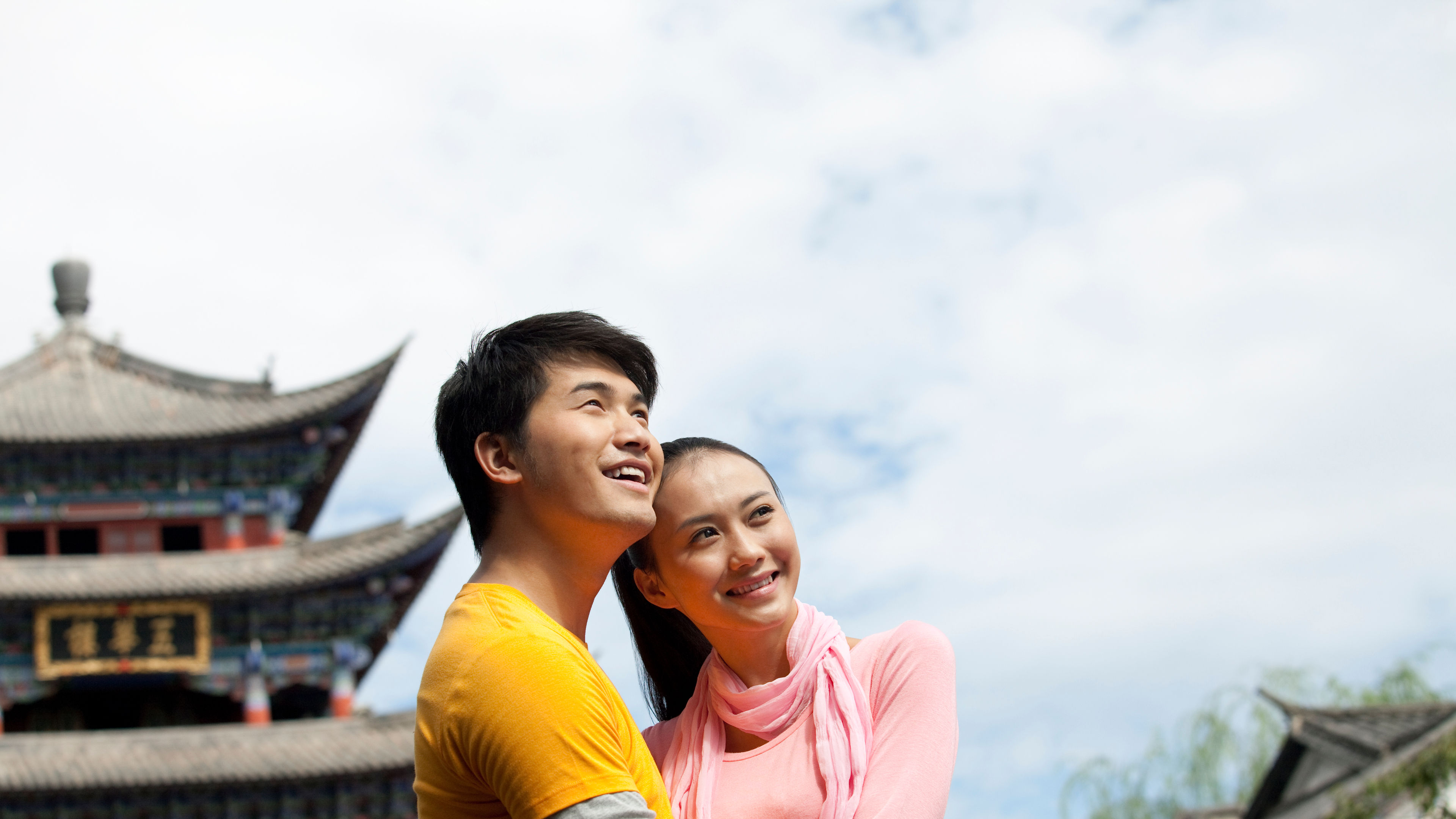 Young Chinese couple embracing in the street of Dali.