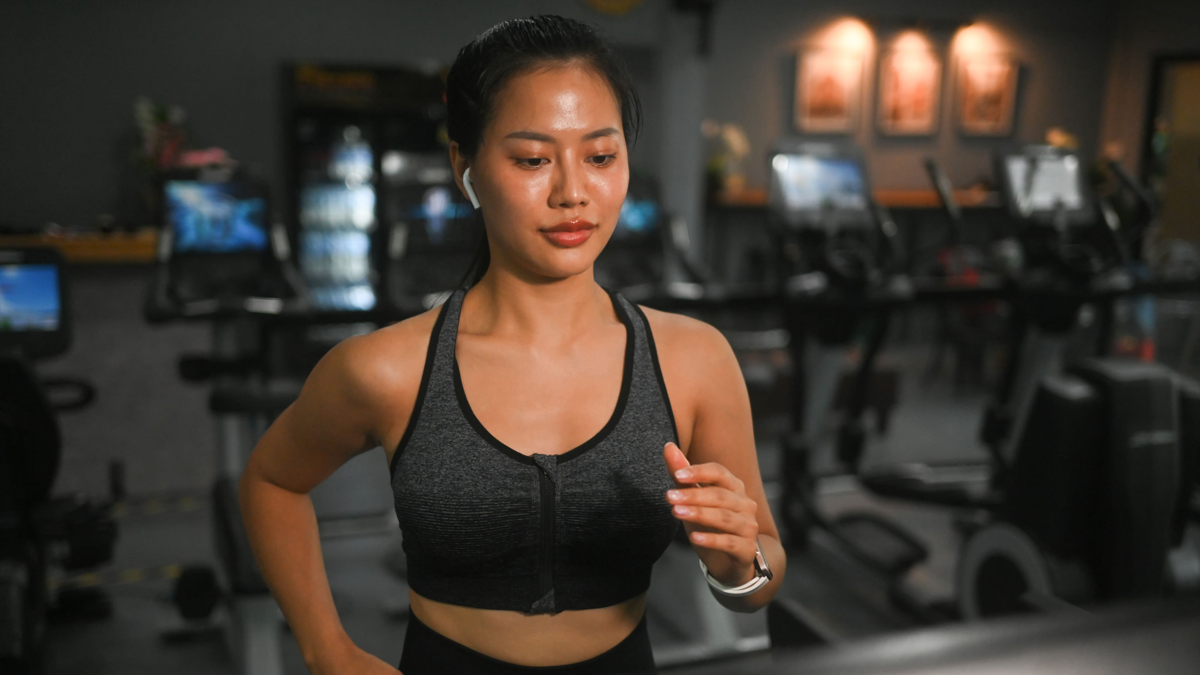 A young lady wears a stylish sports bra while engaging in fitness activities. 